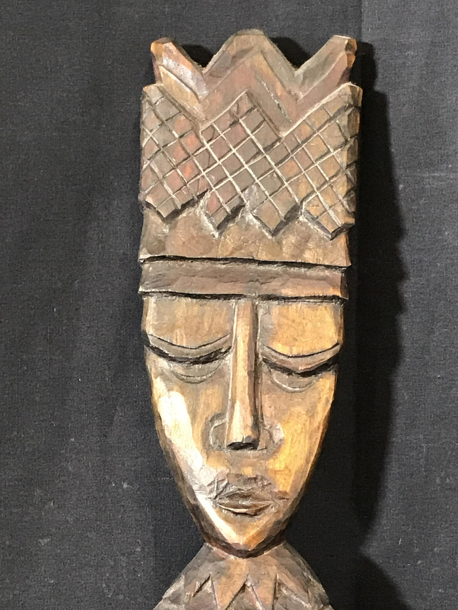 Hand Carved Wood Totem: Hand Carved Wood Totem, carving consists of three figures in crisscross pointed crowns, Wood is stained with various reds and browns, has two hanging hooks on the back, measures 31.5 inches tall, Hand