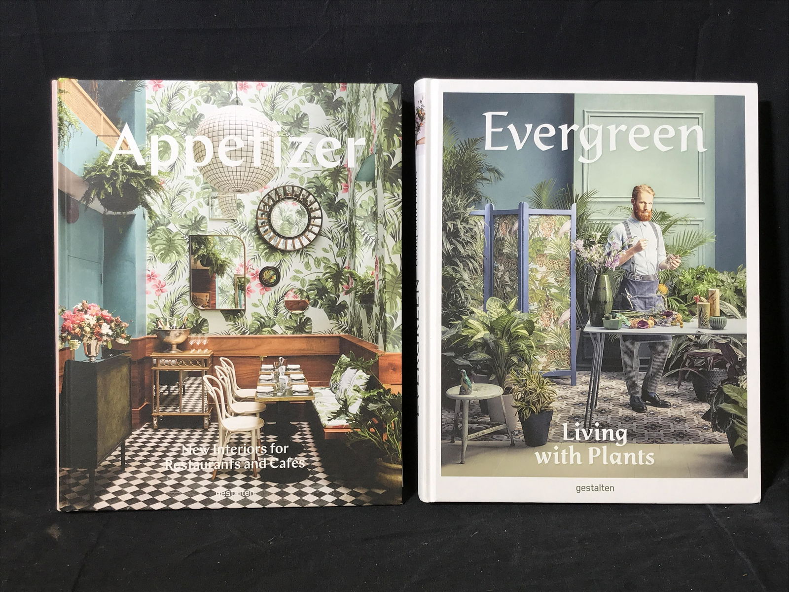 Set of New Coffee Table Books On Interior Design: Set of 2 new coffee table books on interior design, titles include ‘Appetizer: New Interiors for Restaurants and Cafes’ and ‘Evergreen: Living with Plants’, largest book measures 12 inches tal