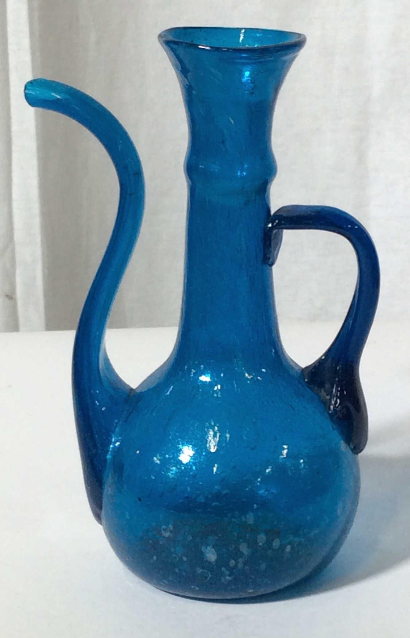Lot 4 Israeli Glass, Middle Eastern Collectibles: 5 pcs. Pink Israeli Vases, tallest 8 1/4 x 5 in. Middle Eastern pierced Metal, glass beverage container. Blue art glass Turkish Middle Eastern DALLAH ( cracked spout), thick Walled glass Embossed diam