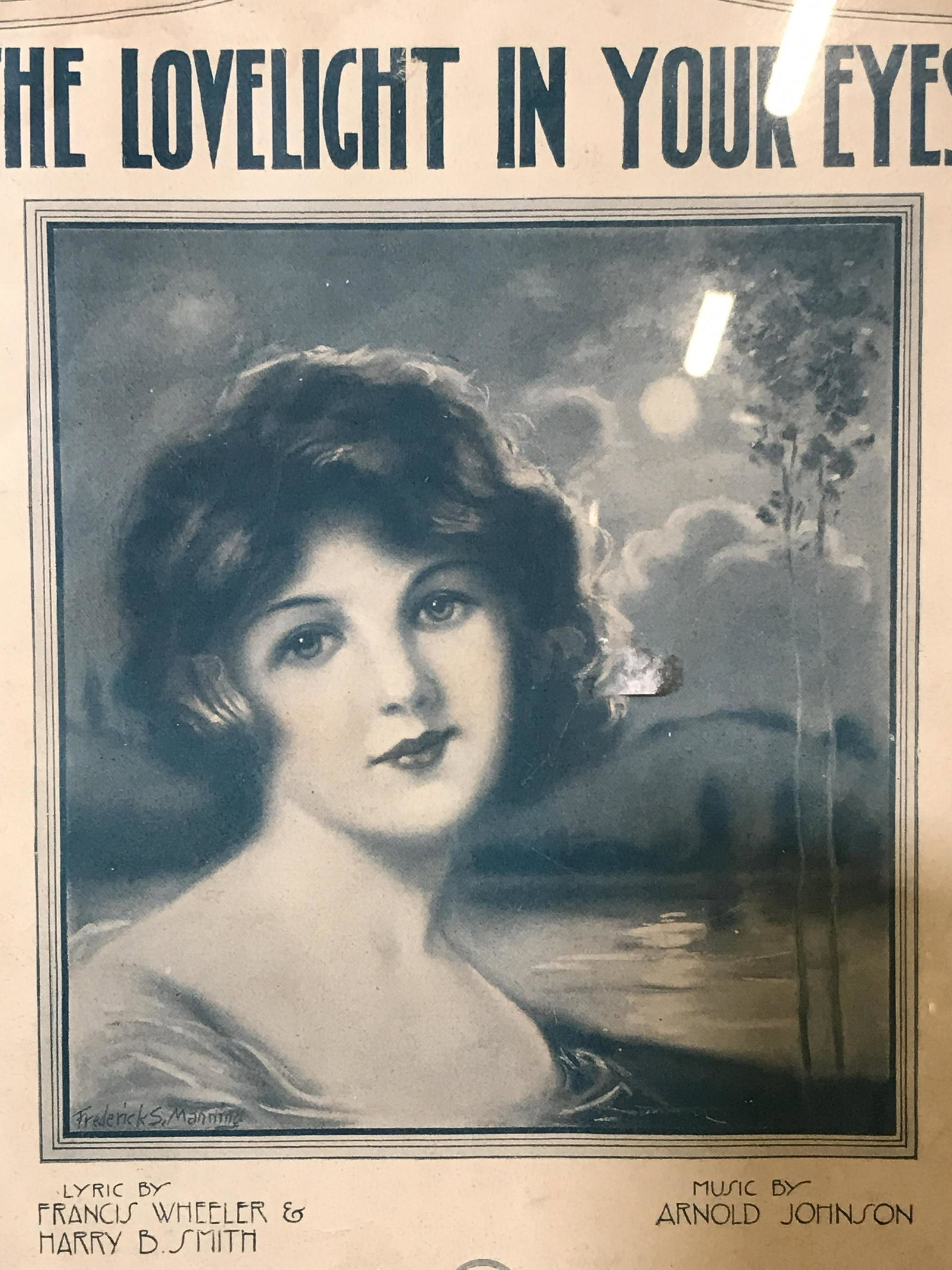Sheet Music Cover ‘The Lovelight in your Eyes’: Sheet music cover ‘The Lovelight in your Eyes’, subject a portrait of a woman in front of a lagoon, text to lower border reads ‘Lyrics by Francis Wheeler & Harry B.Smith, Music by Arnold Johnson
