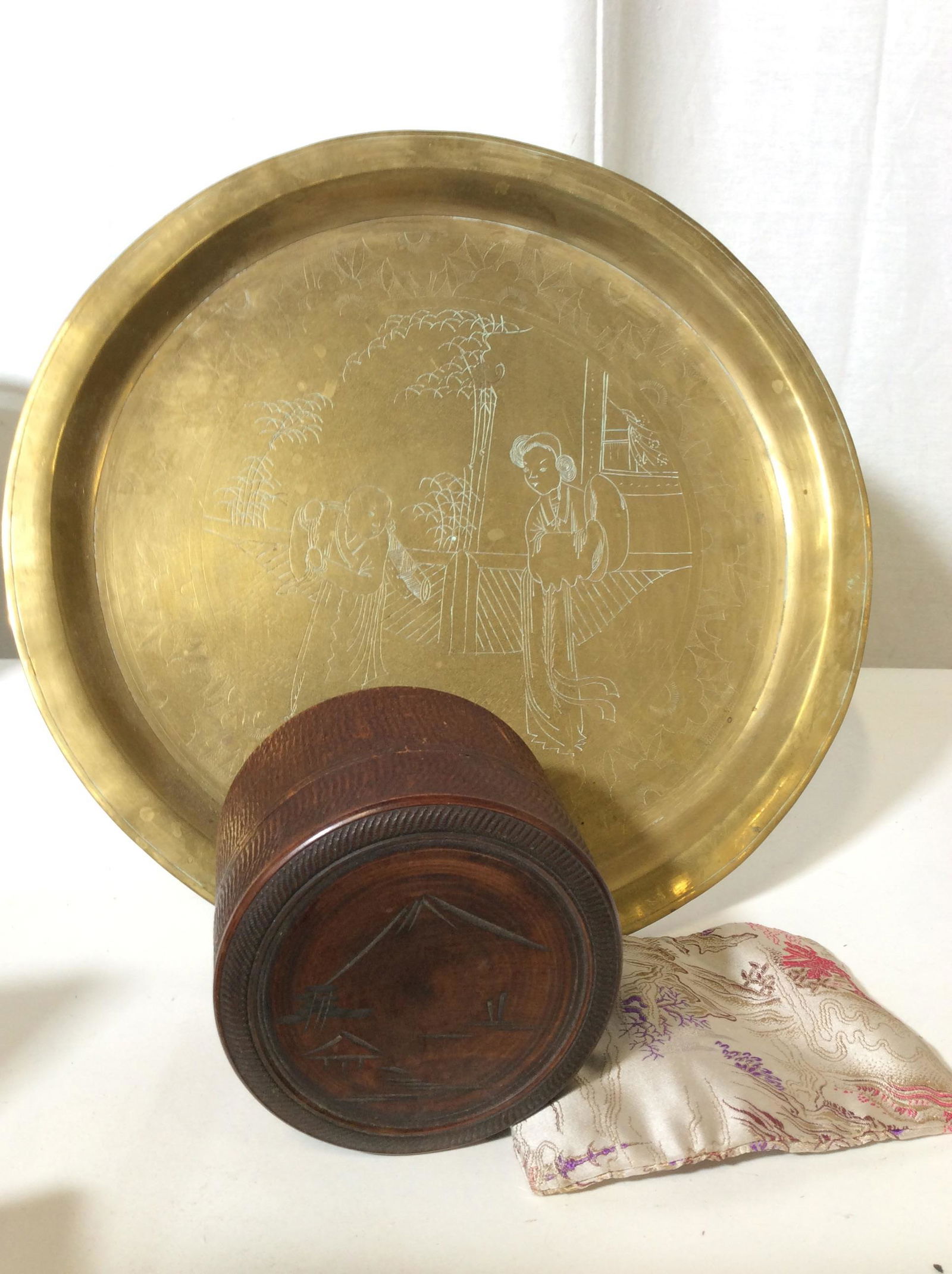 Lot 3 Decorative Asian Arts Objects: Vintage Etched Brass Serving Platter with rim 12 1/4 in diameter. Handmade Etched Wood Box depicts volcano landscape, Round, Lid removable, Hand crafted Asian Ring Pouch Holder , Made in China , Label
