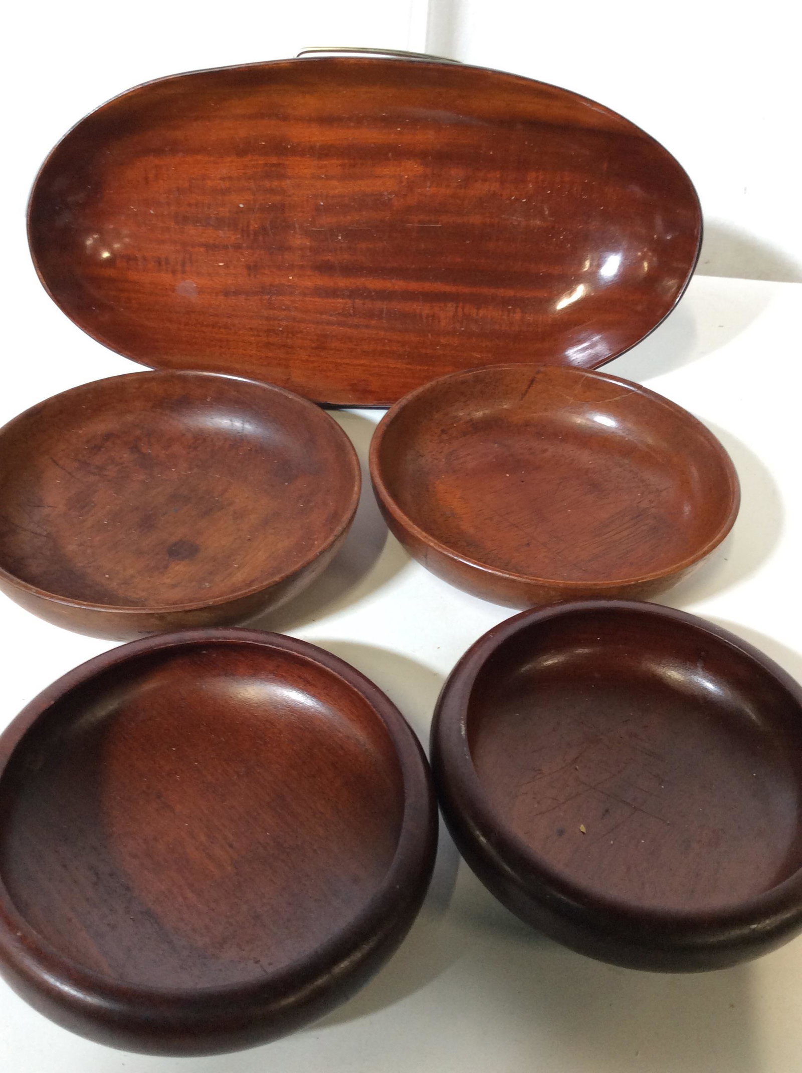 Lot 5 Vintage Indonesian Wood Tableware: Oval Shallow Bowl, 14 x 7 in. Rice Bowls, 2 are 6.5 in diameter ( fixed crack to one), pair of rimmed rice bowls 6 in diameter. Possibly wood from Indonesia, Thailand, South Pacific. Serving Bowls, Tr