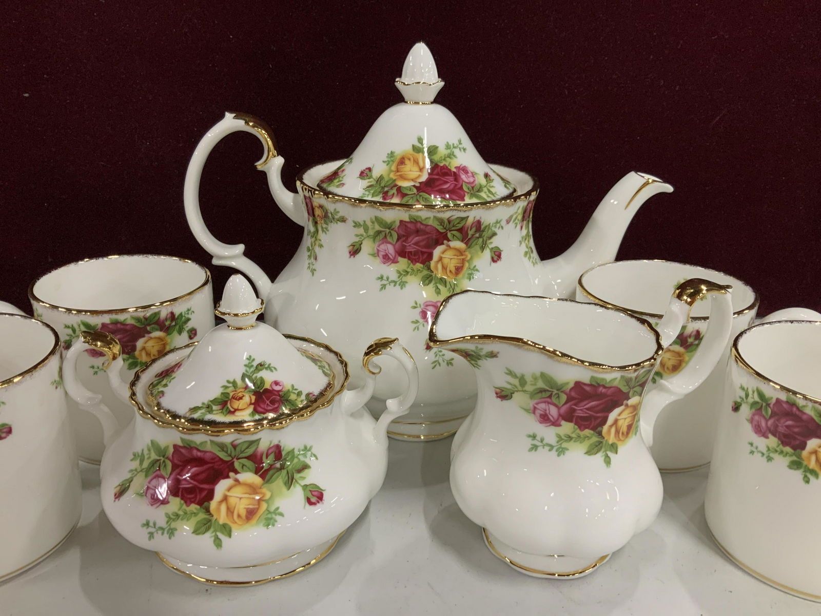 Royal Albert Roses English Porcelain Tea Service: Underside reads old country roses, Royal Albert bone China, set includes lidded sugar, creamer, tea pot ht app 8.5 inches width 11,5 inches, four mugs, coffee service, tea service, porcelain table war