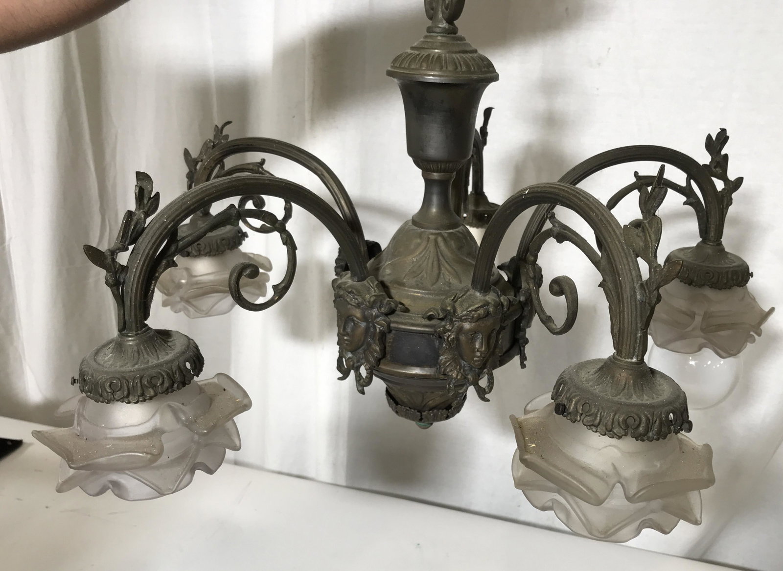 Vintage Floral Rococo Style Chandelier: Vintage floral rococo style chandelier, base of chandelier is metal with floral designs and faces, five arms with glass flower petal shades missing one shade, some wear to chain, some white paint to c