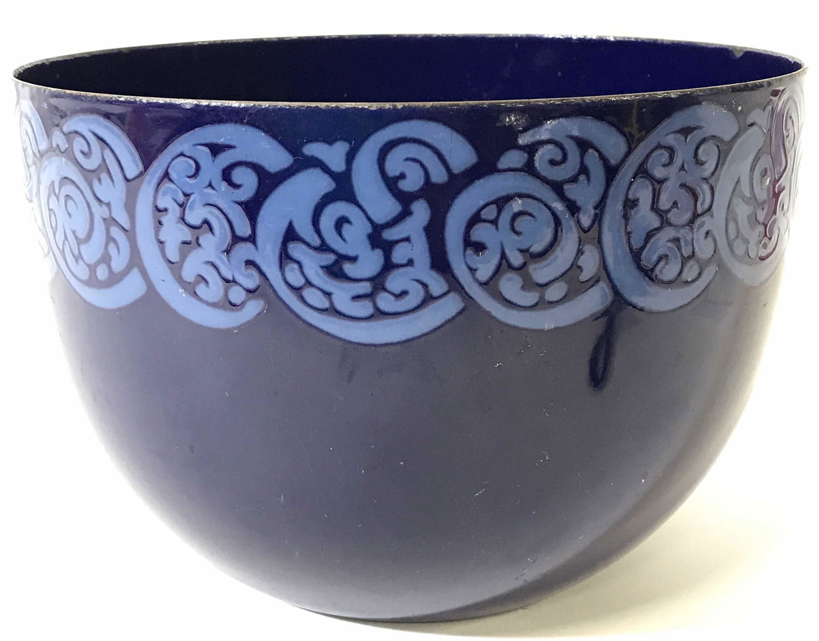 Blue Toned Enameled Vessel: Bowl is blue toned. Piece is enameled. Contains light blue pattern detail on outer area near rim. Piece measures approximately 5.5 inches tall 8.5 inches wide. Bowl, enameled bowl, enameled vessel, bl