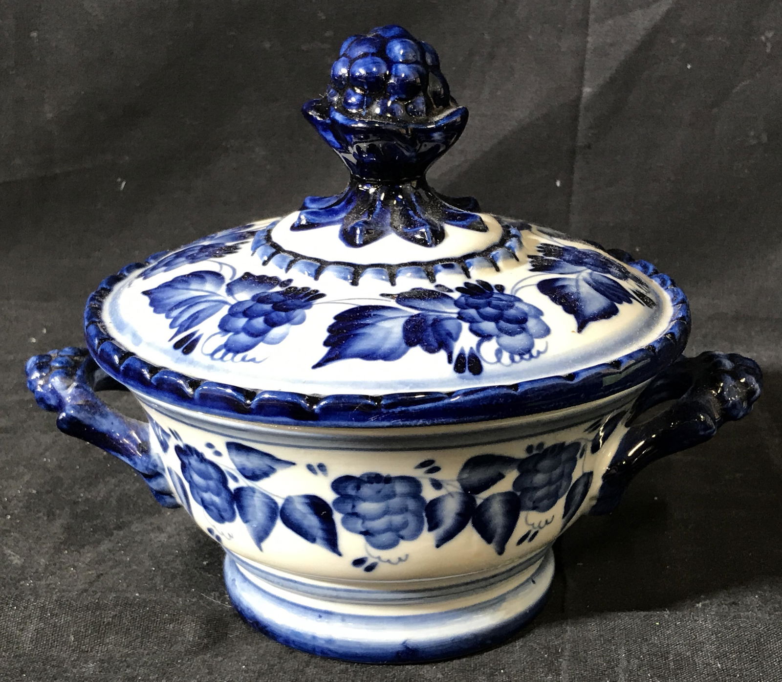 Russian Porcelain Lidded Bowl: Russian Porcelain Lidded Bowl, entirety of bowl decorated with blue flowers, stamp to bottom of bowl reads Handmade in Russia, bowl measures 6.25 inches in diameter, has two handles no either side, Ru