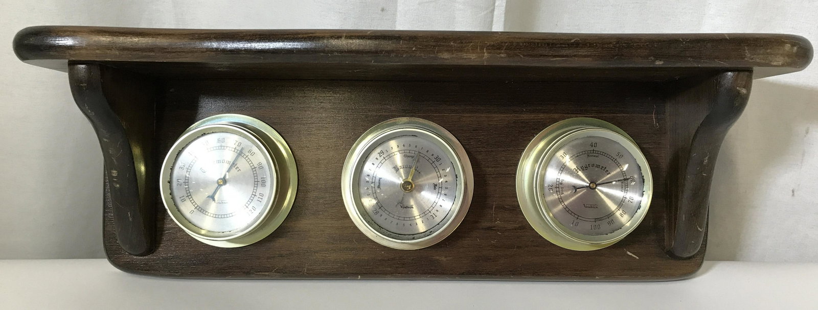 Vintage Weather Instrument: Vintage weather instrument, can be wall mounted to act as a shelf. Contains a Thermometer, Barometer, and a Hygrometer. Face of each meter reads VERICHRON. Measures approx 6.5 inches H, and 17.25 inch