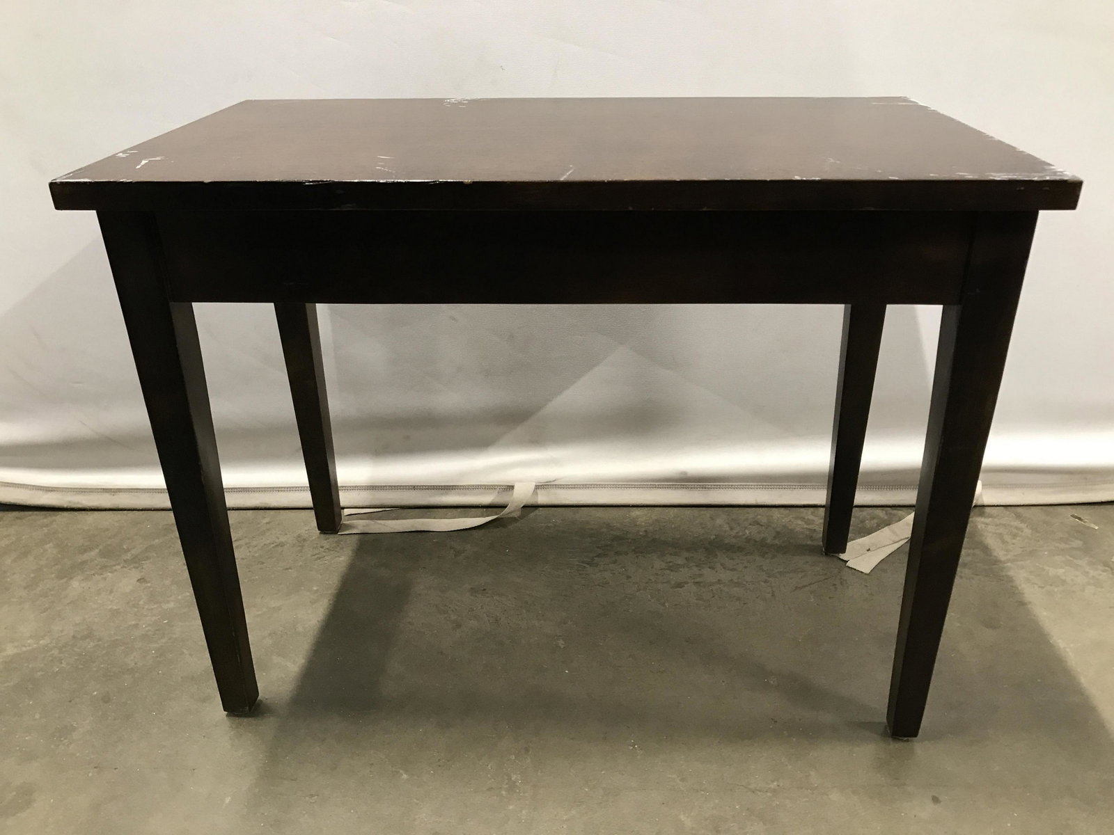 Vintage Wooden Side Table W Storage: Side table is brown toned and wooden. Piece is vintage. Table has flip open top to reveal storage area. Piece measures approximately 19inches tall 25 inches long 14 inches deep. Piece has evident wear