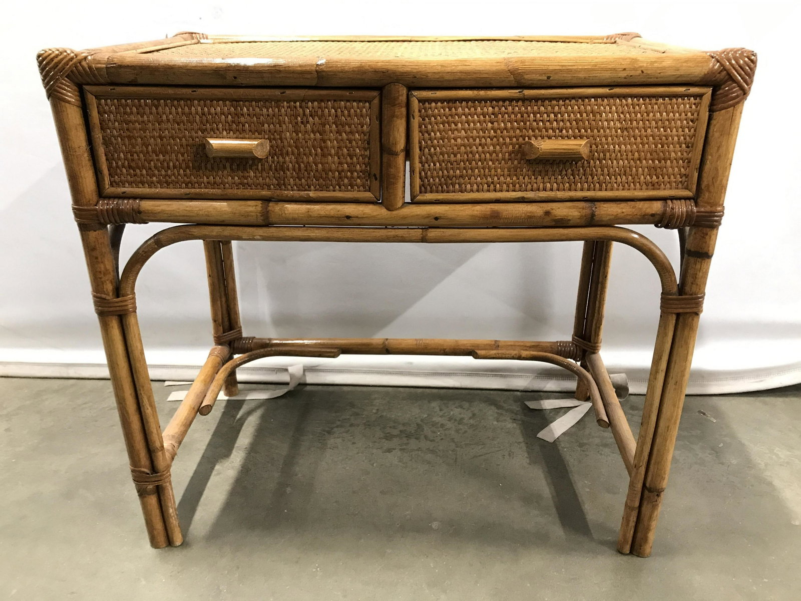 Bamboo & Wicker Side Table W Drawers: Side table has 2 drawers. Piece is possibly genuine bamboo and appears to be wicker. Side table is tan toned. Side table, table, table with drawers, bamboo side table, wicker side table. Piece measure