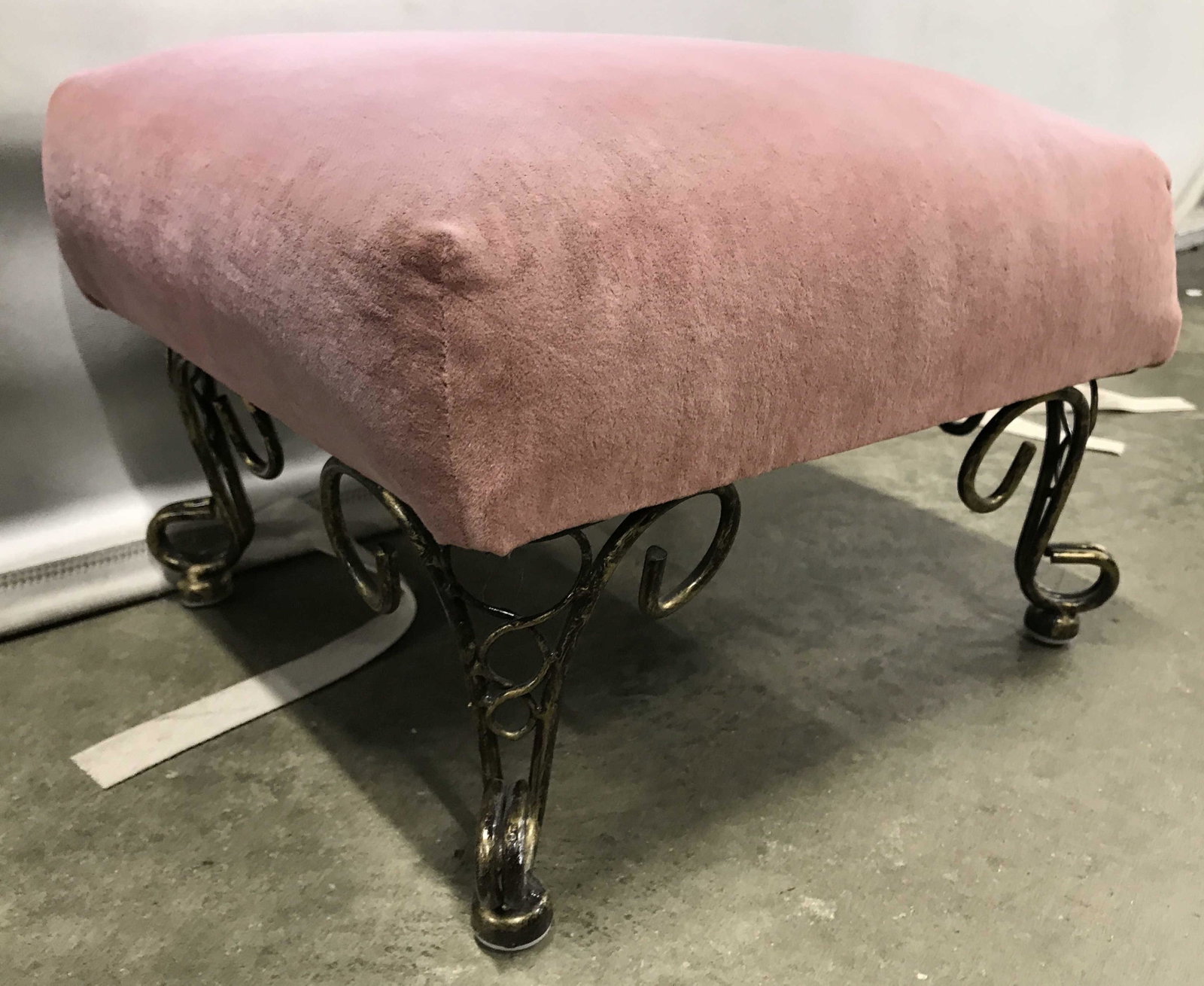 Vintage Mauve Toned Upholstered Footstool: Footstool is vintage. Piece has mauve toned upholstery. Piece has gold toned metal feet with c and s curve detail. Piece measures approximately 14 inches long 10 inches wide 9 inches tall. Footstool, 