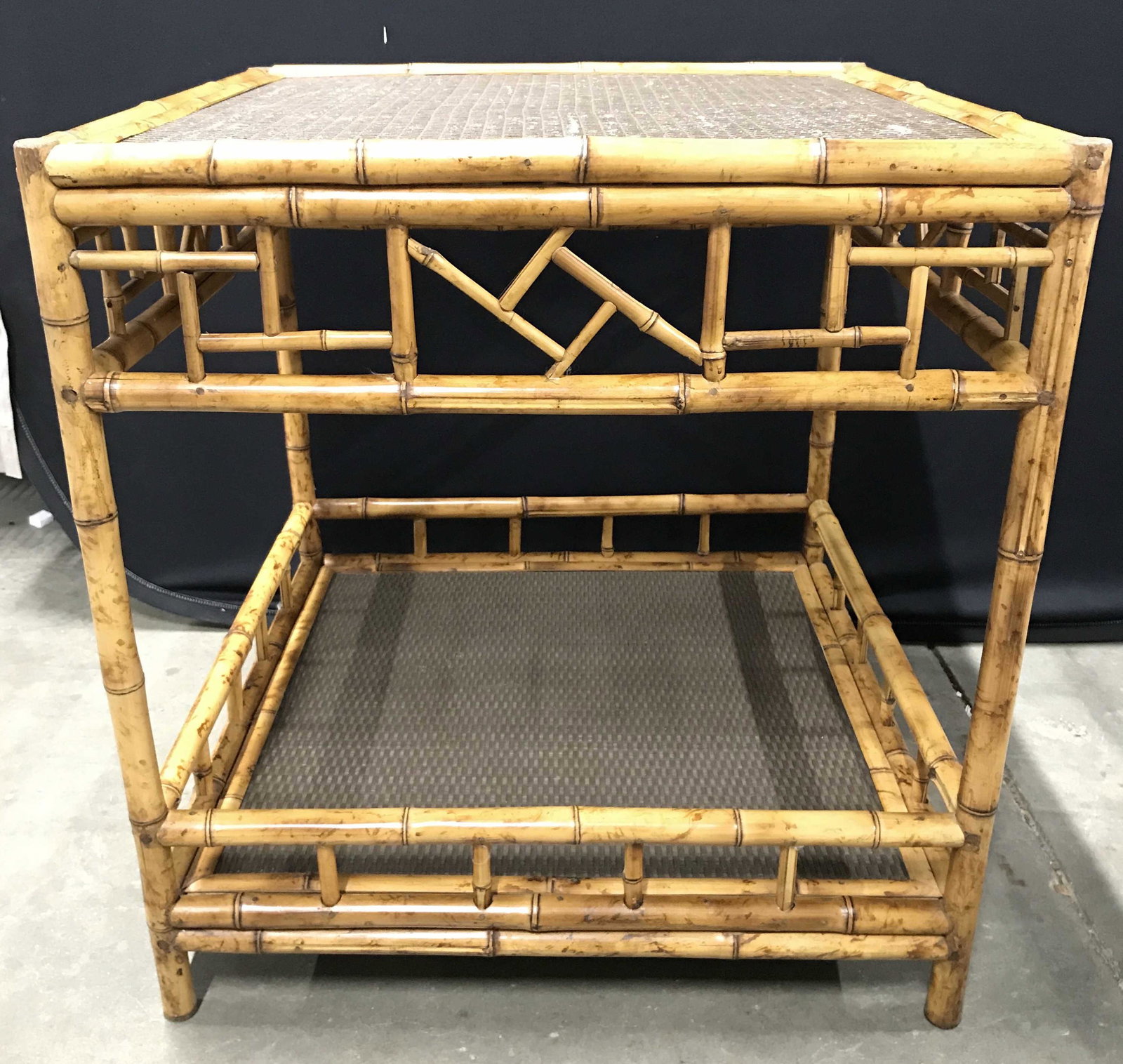 Rattan Bamboo Side Table: Side table is brown and tan toned. Piece appears to possibly be genuine bamboo. Piece has lower level stretcher shelf with bamboo style gallery. Side table, end table, lamp table, bamboo table, bamboo