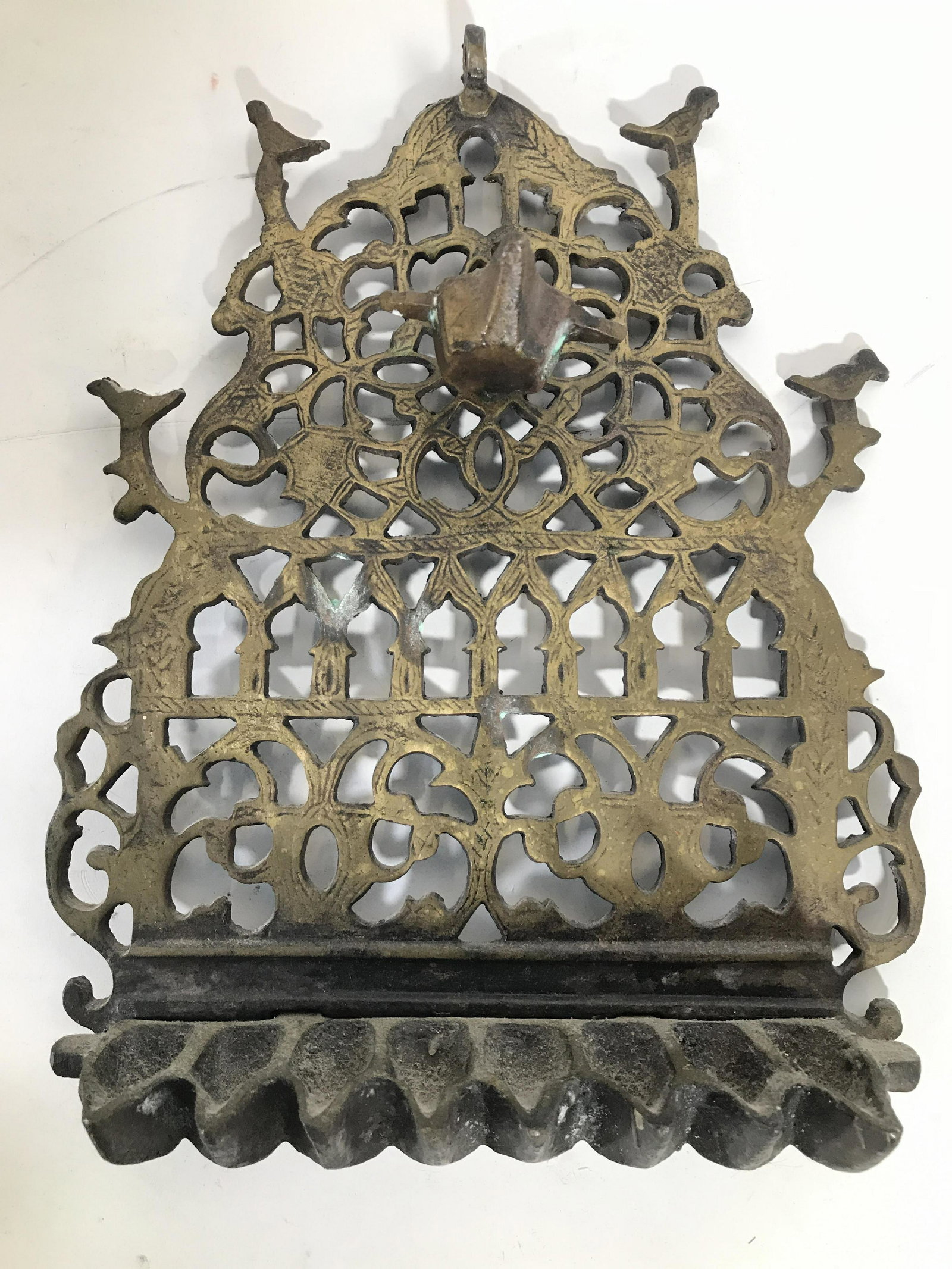Vintage Gold Toned Brass Judaica Menorah: Mental is gold toned and brass. Piece is vintage possibly antique. Piece has pierce detail. Menorah appears to have hanging loop at top. Piece measures approximately 11 inches tall 9 inches wide. Meno