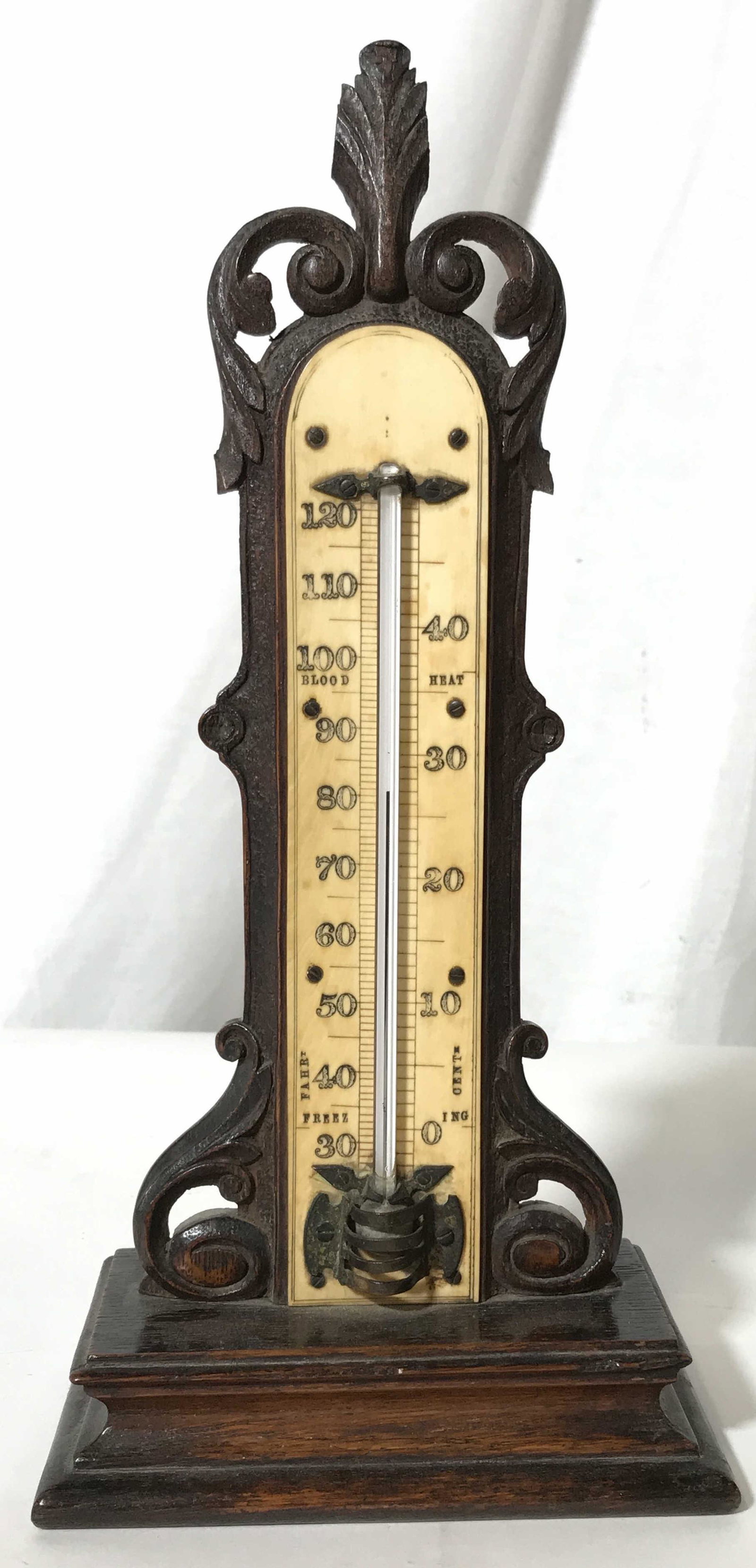 Vintage Wooden Thermometer: Vintage thermometer. Wooden, bulb housed in metallic cage, temperatures, and descriptions are carved into the structure. Measures approx 11.5 inches H, and 5.75 inches W. Wear is consistent with age. 