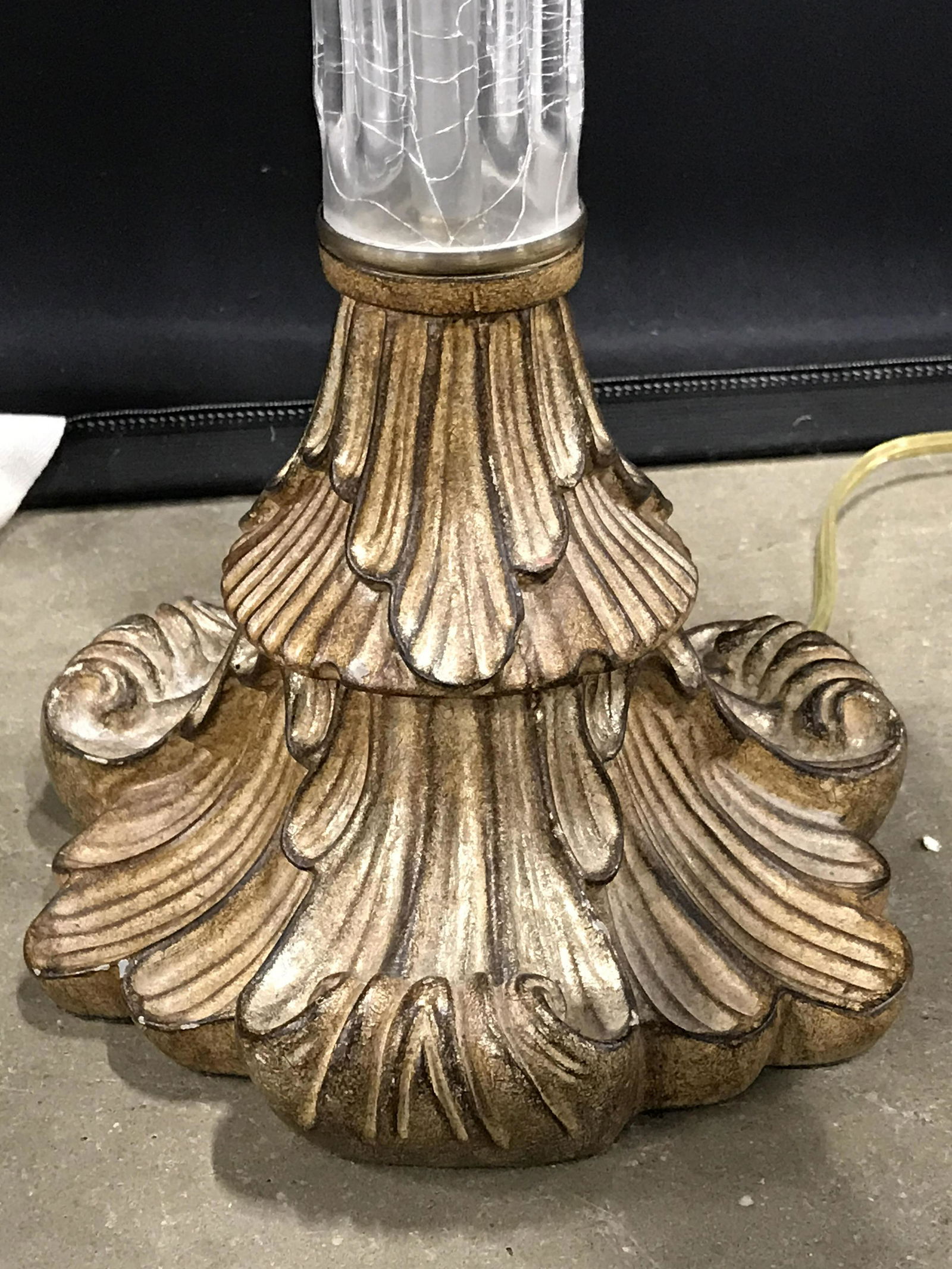 Vintage ALEXANDER JOHN Lamp: Underside has tag which reads ALEXANDER JOHN. Lamp is vintage. Piece has carved gold toned base. Center of lamp body appears to be glass. Lamp includes shade & finial. Finial is gold toned with carved