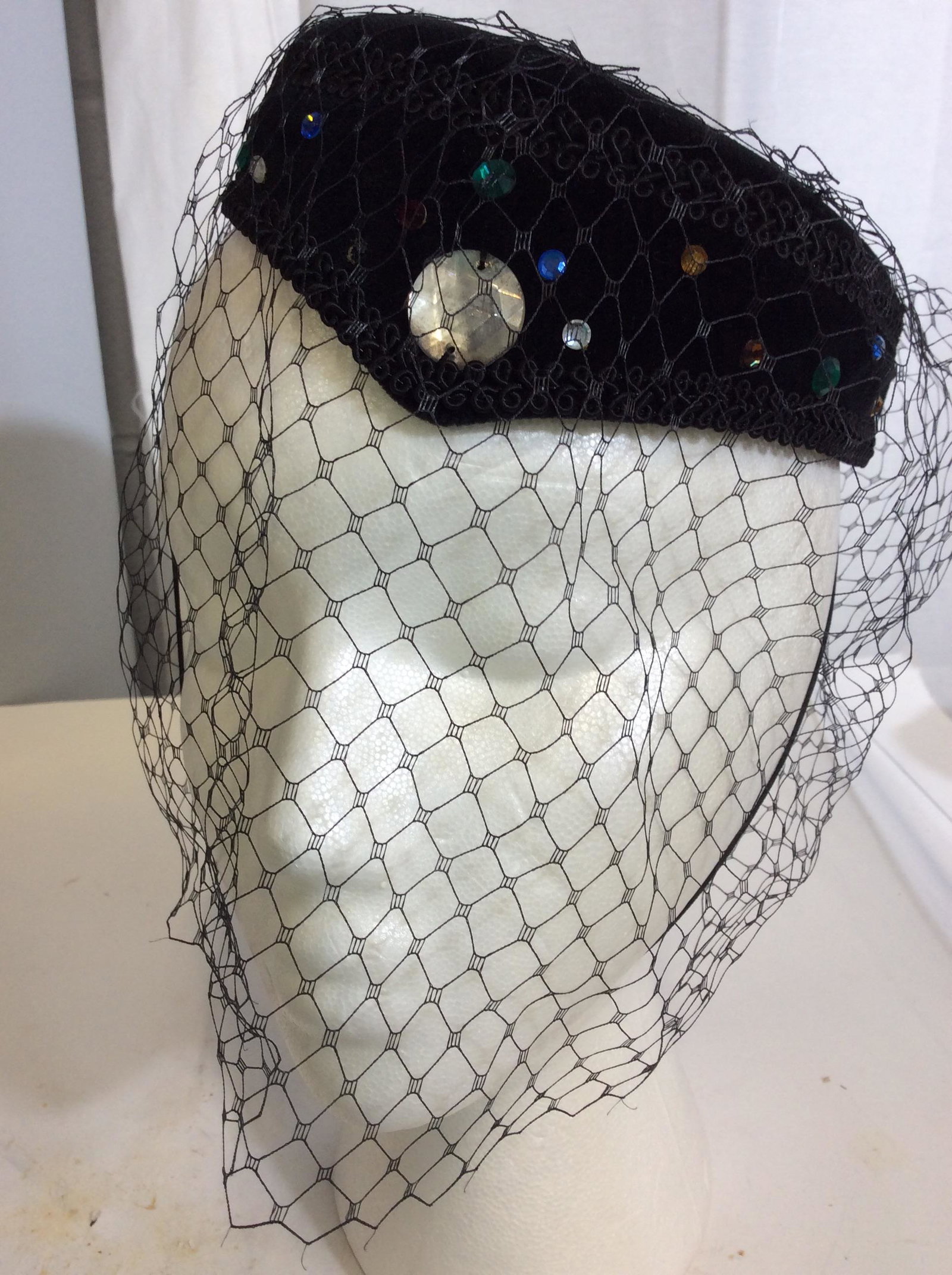 Colored Rhinestone Plush Facinator w Face Net: Decorative , delicate netting, Black Plush Facinator Hat with colorful rhinestones, large center temple rhinestone round. Appliqué Piping. Hat 7 x 6 in. Stretch chin band. good vintage condition. Fac