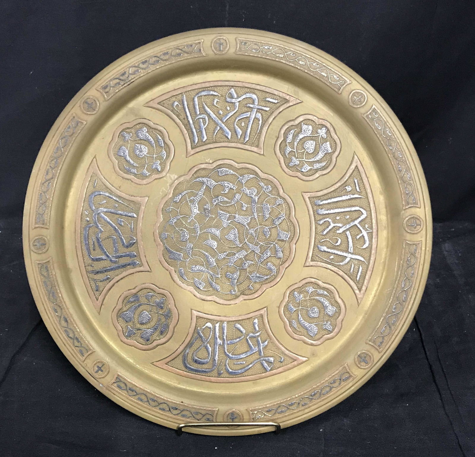 Painted Bronze Tone Plate: Painted bronze toned plate, no apparent signatures or stamps, floral design and arabic script. Measures approx 14 in in diameter.Painted bronze, bronze plate, bronze, polished bronze, decorative plate