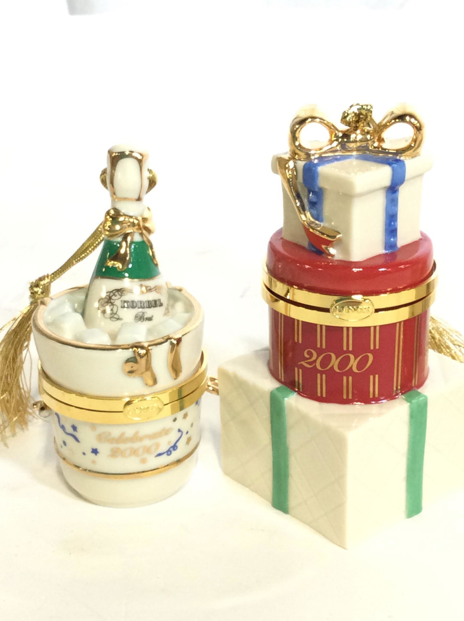 Collectible LENOX China Tree Ornaments, 5 pcs: Hand Crafted Porcelain Christmas Tree Ornamets. All Hallmarked. Some objects include year 2000. Lot includes rocket ship, tea cup & saucer, Tea Pot, Champagne Bottle In ice bucket, and stacked Christm