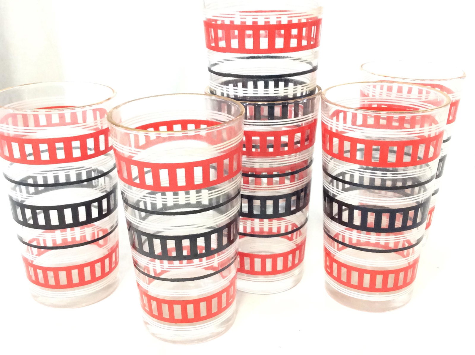 Set 6 Vintage Beverage Glasses: Purchased in USSR, possibly Ukrainian or Russian Red & Black Decor. Exterior embossed decal, glasses 5 in ht, 2 3/4 in diameter. Gilt rim. 2 stuck together. Beverage glasses, Ukrainian Russian Pattern