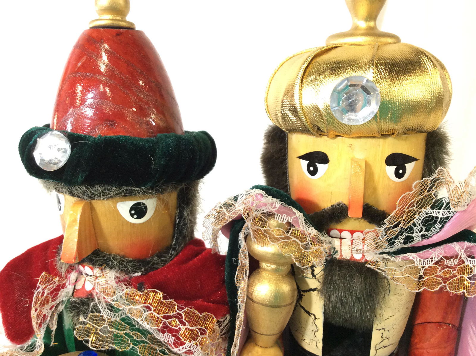 Pair Decorative Wood Nutcrackers: Glorious Velvet cape, royal crowns and detailed accessories. Crackle paint on one, polyurethaning on wood. Labeled underside The Christmas Tree Shops. Nutcrackers app. 15 in. Ht, 5 in width. Christmas