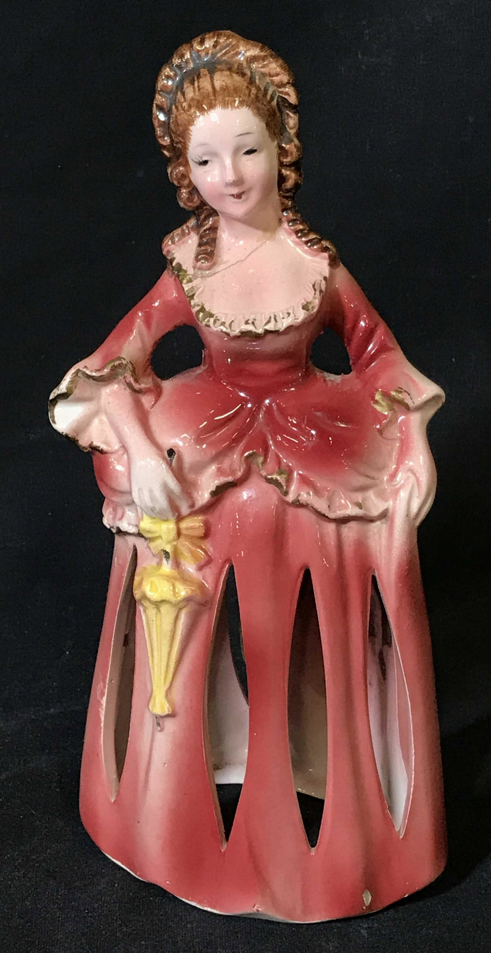 Ceramic Napkin Lady / Bell Decorative Figural: Ceramic aristocratic woman bell, no apparent signatures or stamps, subject a ceramic figurine of a noble woman in a pink Victorian gown with a yellow parasol, completely hollow sections of the gown ha