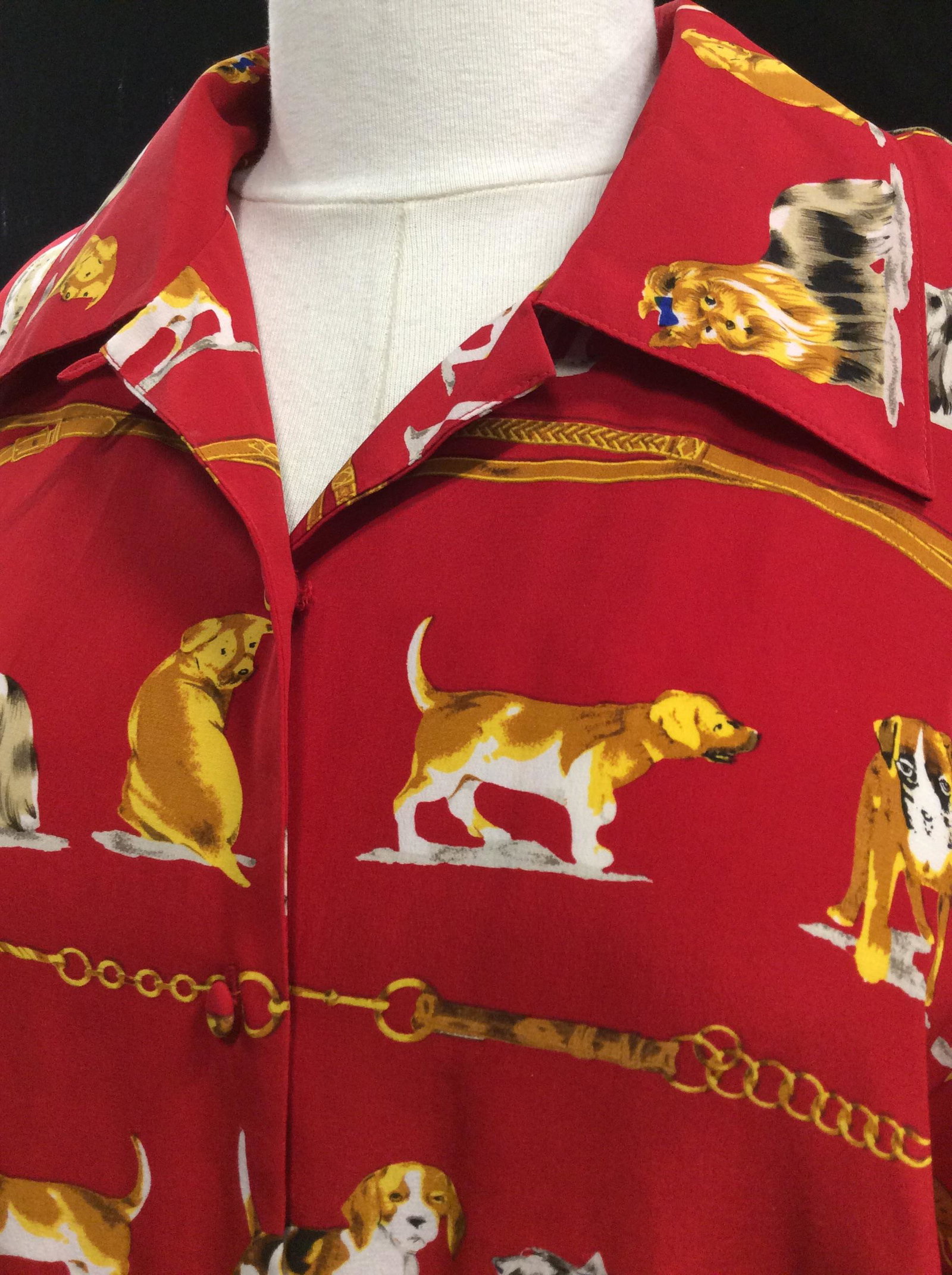 Dog Lovers Button Down Silk Blouse, Corey B.: Red silk long sleeve blouse, fabric covered buttons, wide tailored collar, size M. Designer’s label reads Oreo B. New York, 100 % Silk, Machine Wash Cold. Dogs represented include beagle, Shepard, P