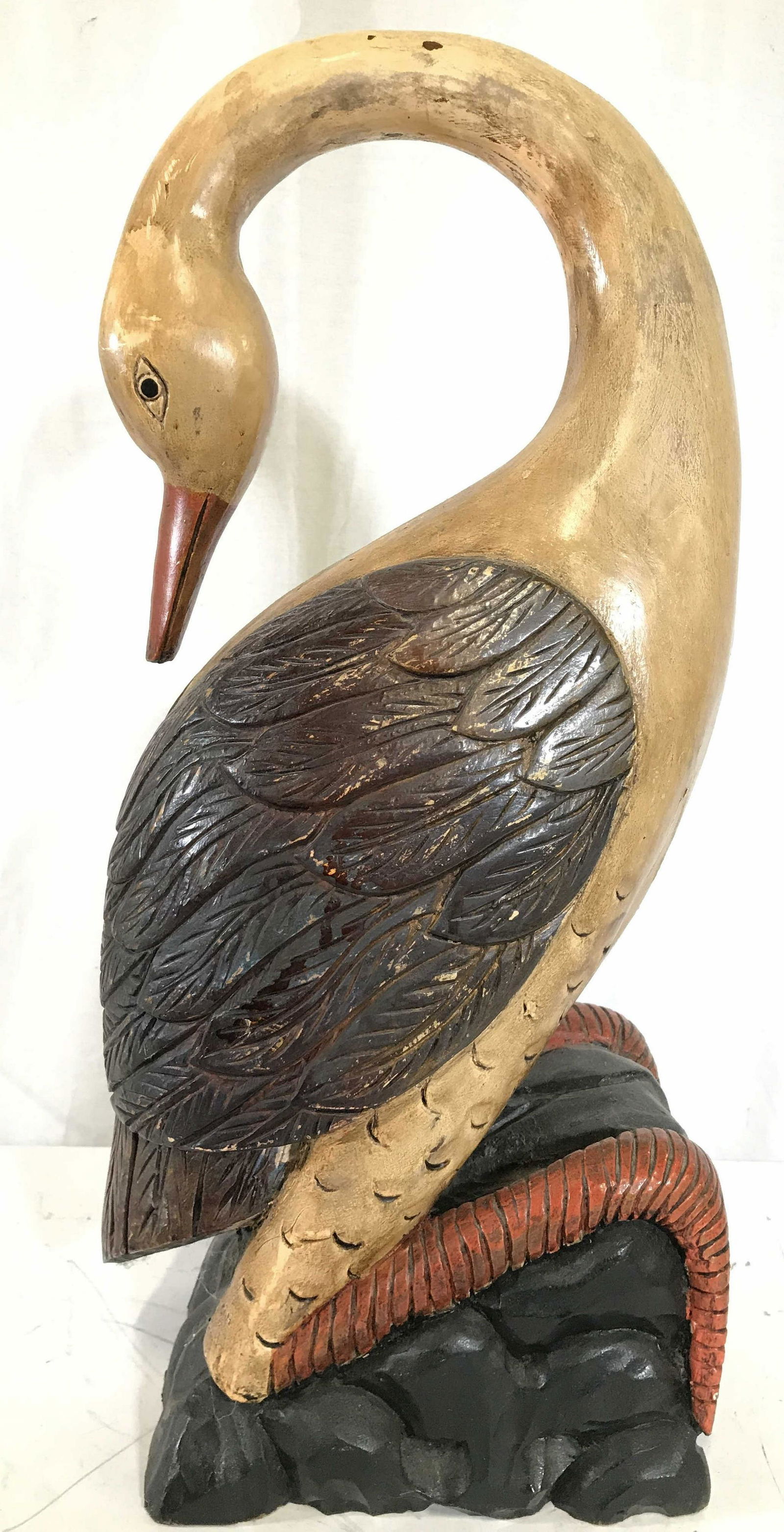 Vintage Carved Wooden Bird Sculpture: Bird sculpture is wooden. Piece is vintage. Sculpture appears to possibly be hand carved & hand painted. Piece measures approximately 22 inches tall 9.5 inches deep 7 inches wide. Bird sculpture, wood