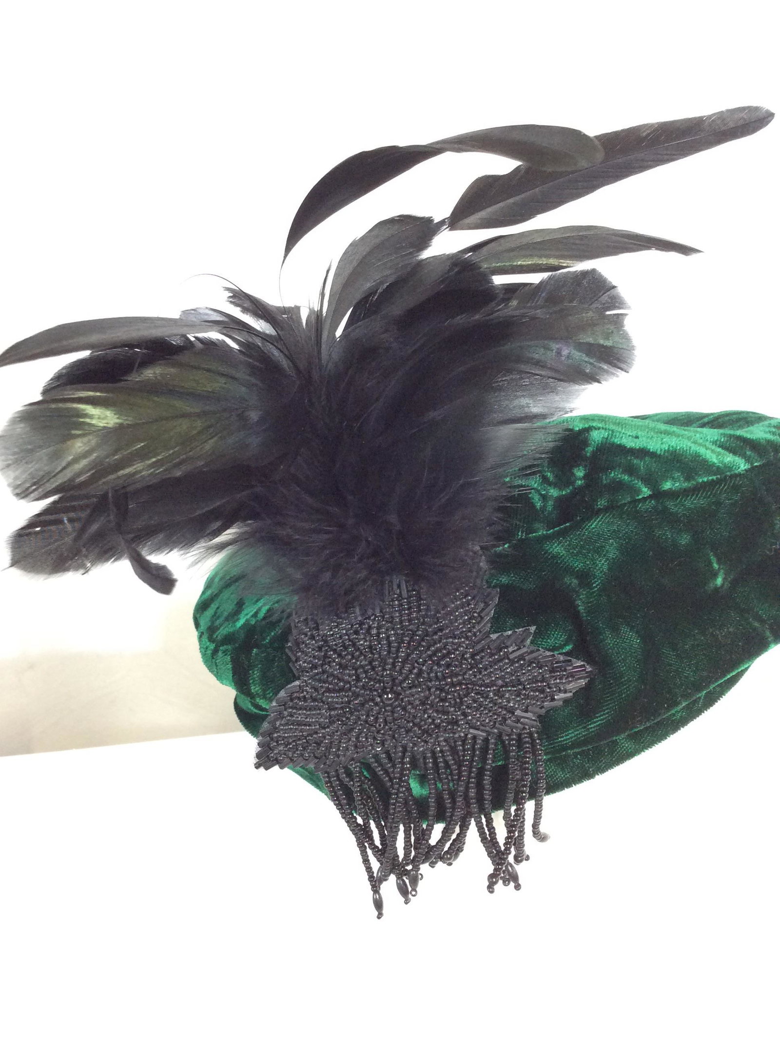 Green Velveteen Feather Cloche Fascinator: Vintage Flapper Style Fascinator Hat with irredescent black pheasant ( possibly) and Duck feathers. Oranate Beaded Leaf With Tassels. Washable green interior fabric, plush hunter green exterior. Clean