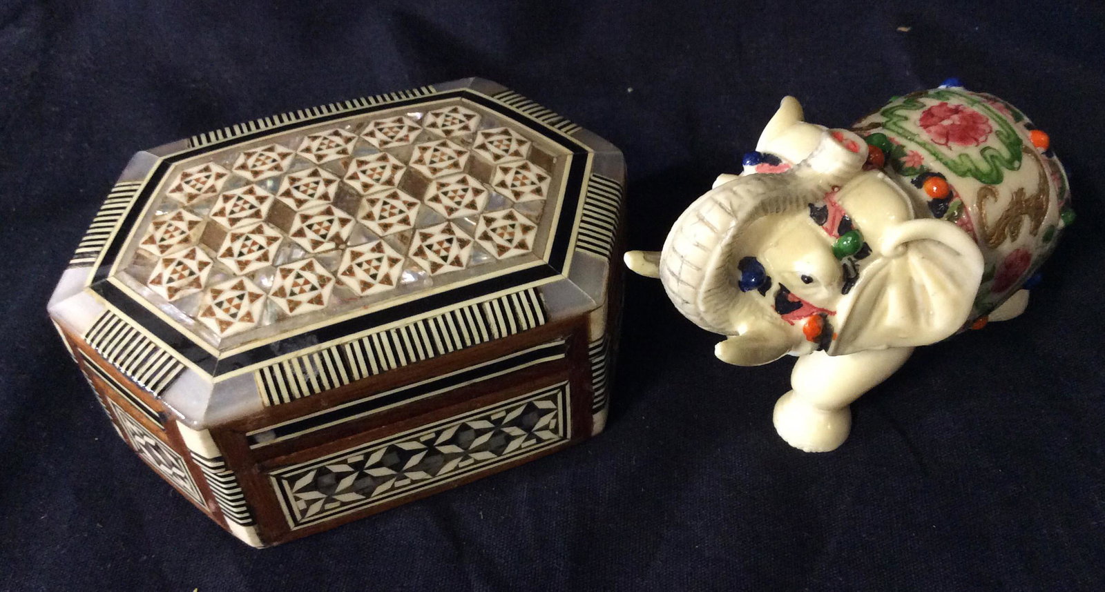 Lot 2 Tabletop Decorative Accessories: Trinket/ jewelry box, Inlaid Mother Of pearl, Hand Painted And shellacked, Star Pattern, Made In Egypt ( sticker on bottom). 4.5 x 3 in. Good luck Elephant Figural with truck upright, Ceremonial decor