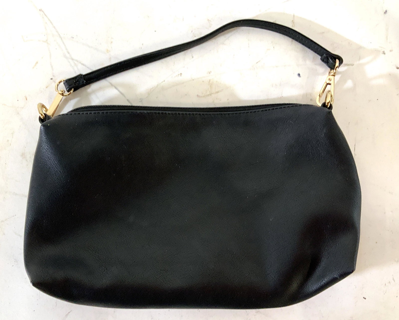 Louenhide Black Women’s Handbag: Louenhide black women’s handbag with handle and gold toned hardware, Engraved inscription reads ‘Louenhide’, Black and white striped interior, has three interior pockets with one zipper, synthet