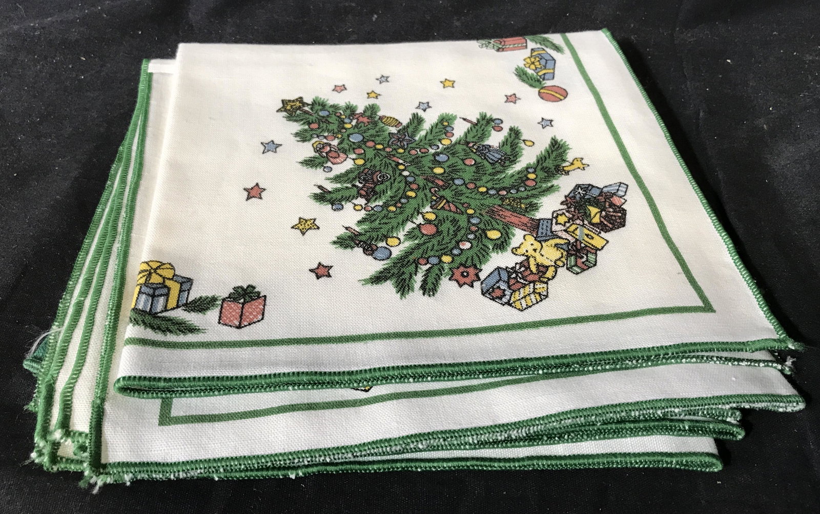Group Lot Christmas Linens: Group lot of 19 Christmas linens, all linens have been cleaned starched and pressed, lot includes 6 red floral napkins, one Christmas candle placemat, 4 Christmas tree napkins and 8 green napkins, lar