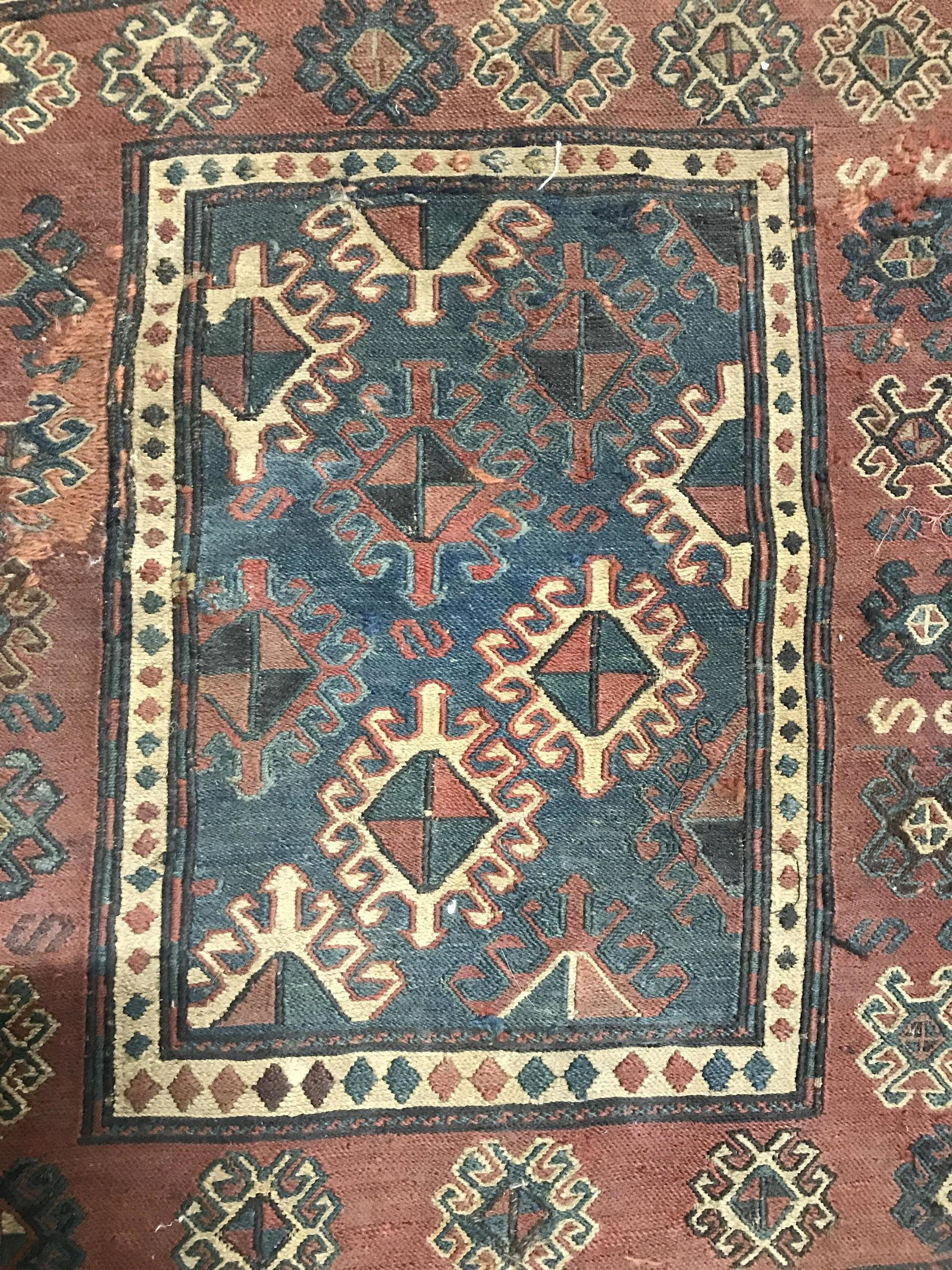 Antique Handmade Rug Sample: Rug is wool & handmade. Piece is antique. Contains multi toned geometric detail. Piece measures approximately 22 inches long 20 inches wide. Rug, carpet, area rug, wool rug, handmade rug, prayer rug. 