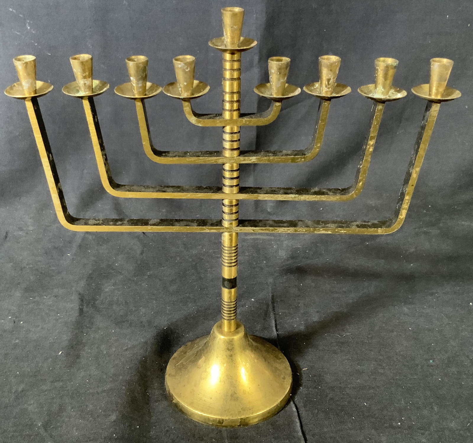 Metal Hanukkah Menorah: Hanukkah Menorah, likely made of brass, has 8 branches plus the shamos which is the elevated center candle that lights all the others, this is a kosher menorah and has decorative lines carved into sha