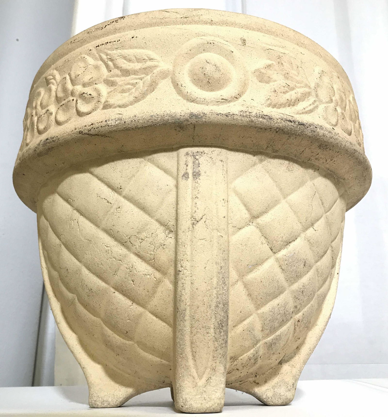 Vintage Cream Toned Ceramic Planter: Planter is cream toned and appears to be ceramic, possibly composite. Piece contains beveled floral & leaf detail. Piece measures approximately 10 inches tall 11.5 inches wide. Planter, ceramic plante