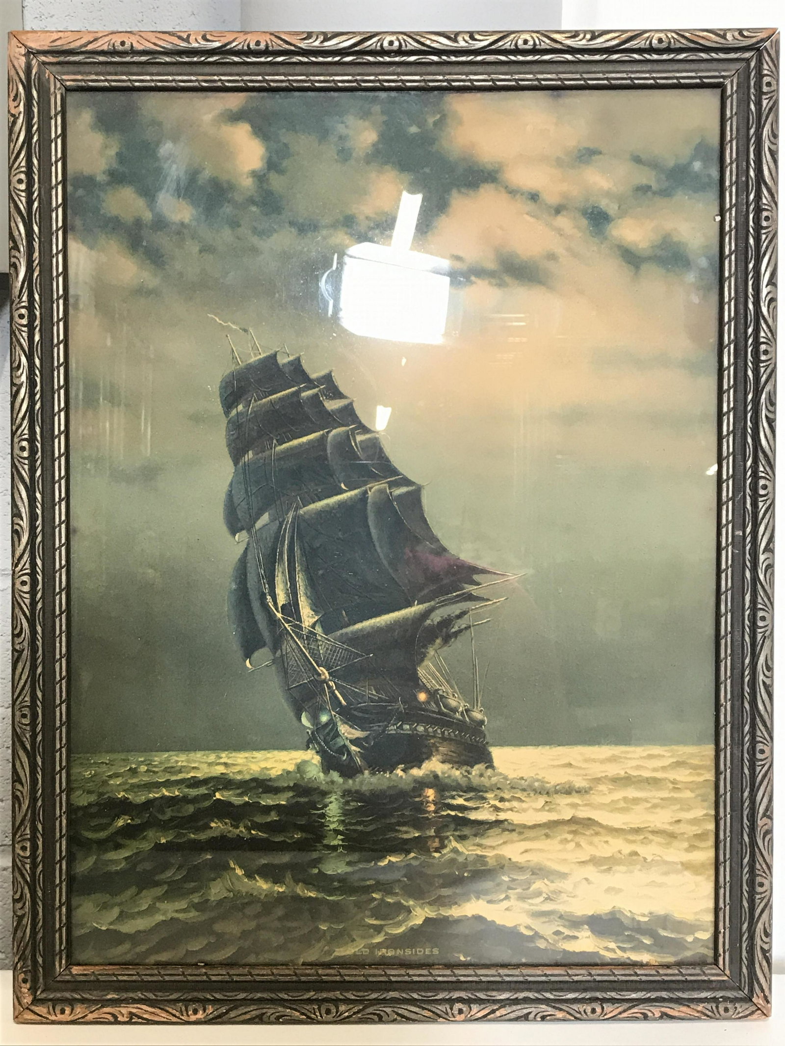 Framed Nautical Print: Print depicts a ship sailing at sea. Piece is professionally framed with slate toned frame. Piece measures approximately 18 inches tall 13.5 inches wide. Nautical print, boat print, wall art, art prin