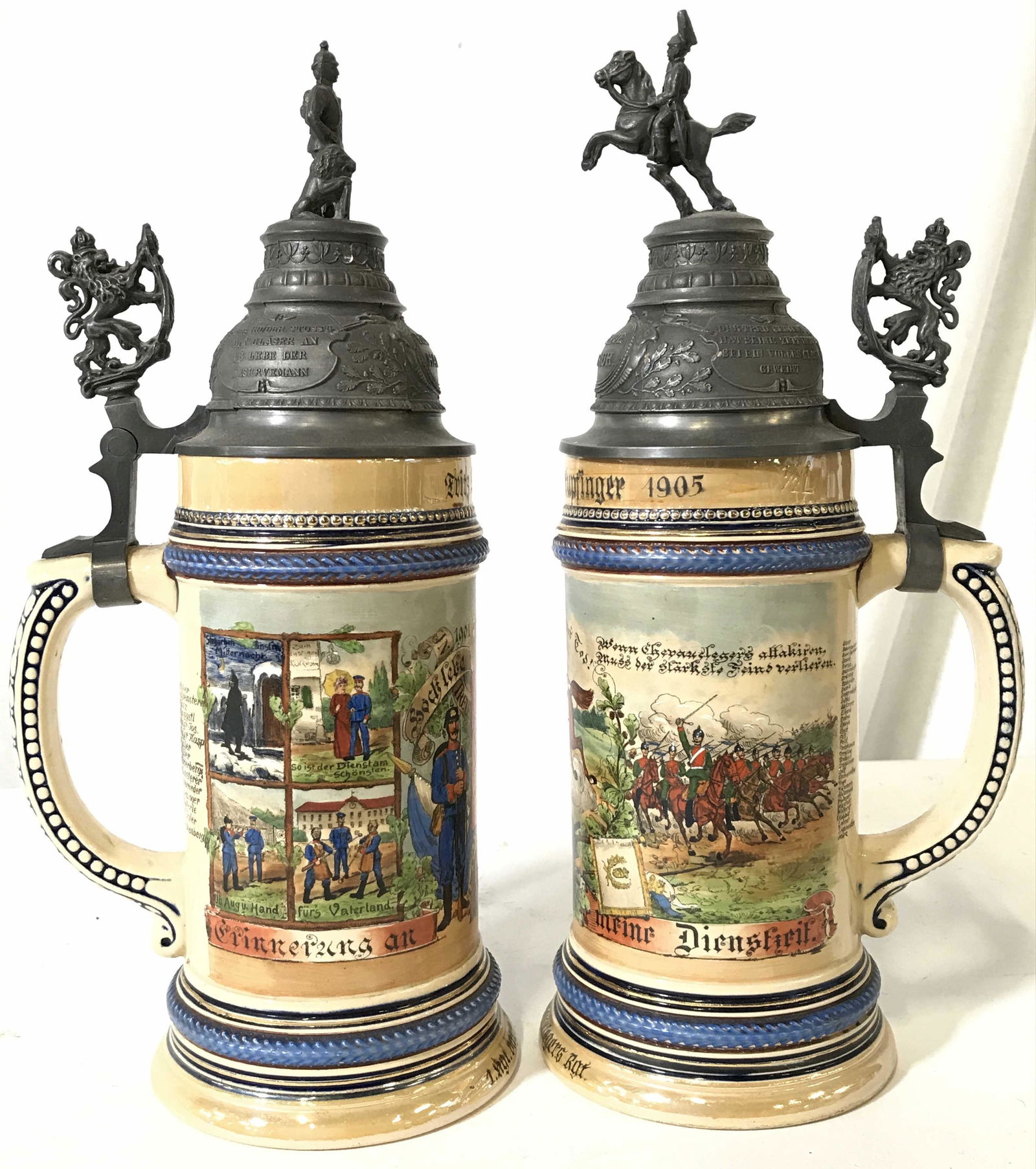 Pair Vintage Ceramic Beer Steins W Pewter Lids: Beer steins are hand painted in some areas. Each Stein is vintage. Steins have intricately detailed pewter lids with horse, soldier and lion detail. Beer steins are German. Each have 1/2 liter capacit