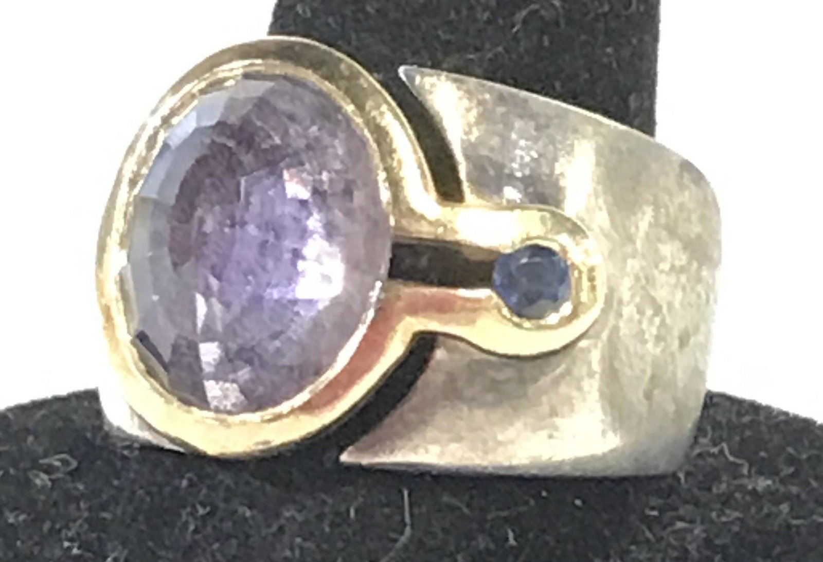 Signed MANFREDI Sterling Silver 14K Amethyst Ring: Luxury Designer and Retailer based in Greenwich, CT. Signed MANFREDI sterling silver ring with 14 K gold bezel. Total weight with stones, .34 Troy Oz. Center solitaire Amethyst, 12 x 10 mm oval, multi