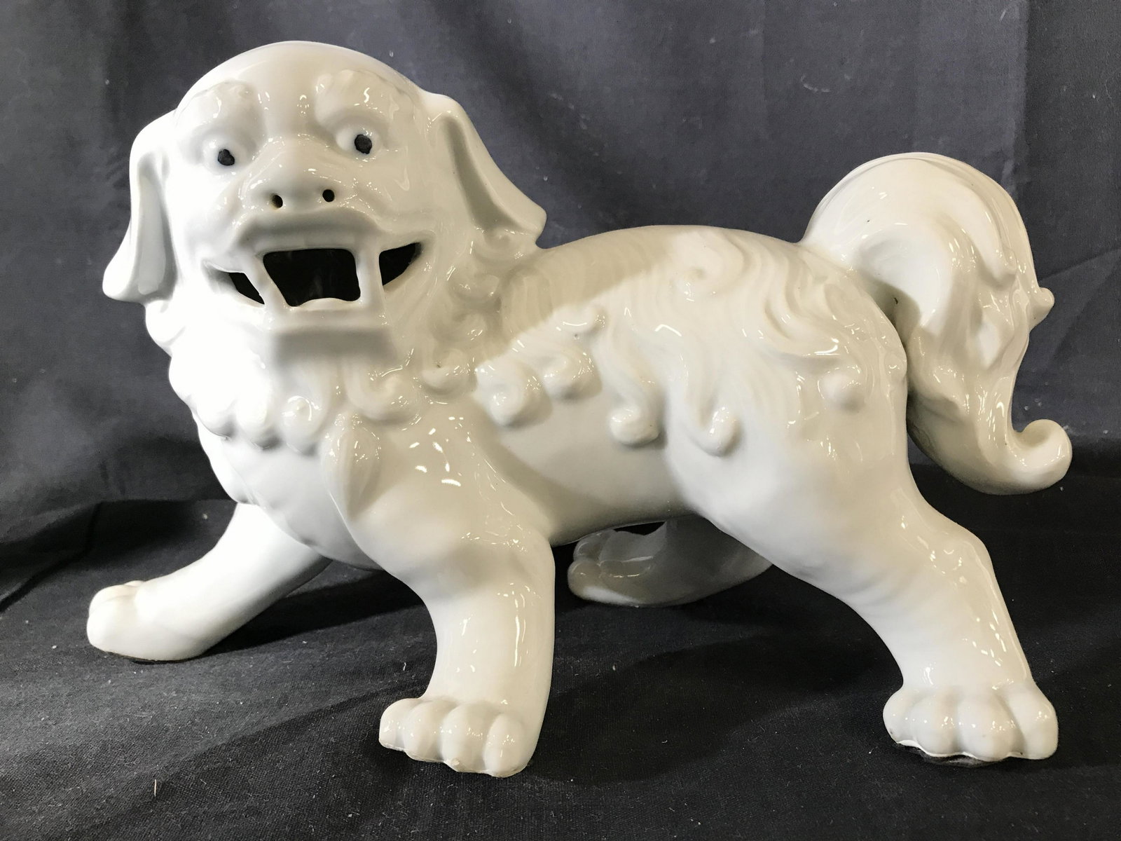 Pair White Toned Asian Foo Dogs: Foo dogs are white toned and porcelain. Each measures approximately 12.5 inches long 7 inches tall 5 inches wide. Foo dogs, temple lions, stoneware, porcelain foo dogs, porcelain temple lions, Asian t