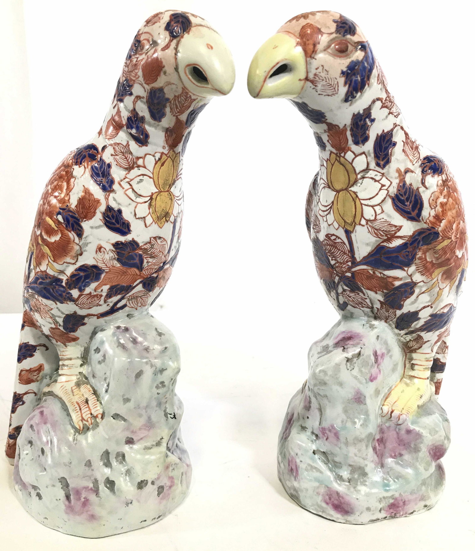 Vintage Signed IMARI Asian Porcelain Parrots: Undersides of Parrot figures are signed with Asian characters. Each are vintage possibly antique. Pieces have intricate multi toned floral & leaf detail. Each piece depicts parrot perched on rock. Por