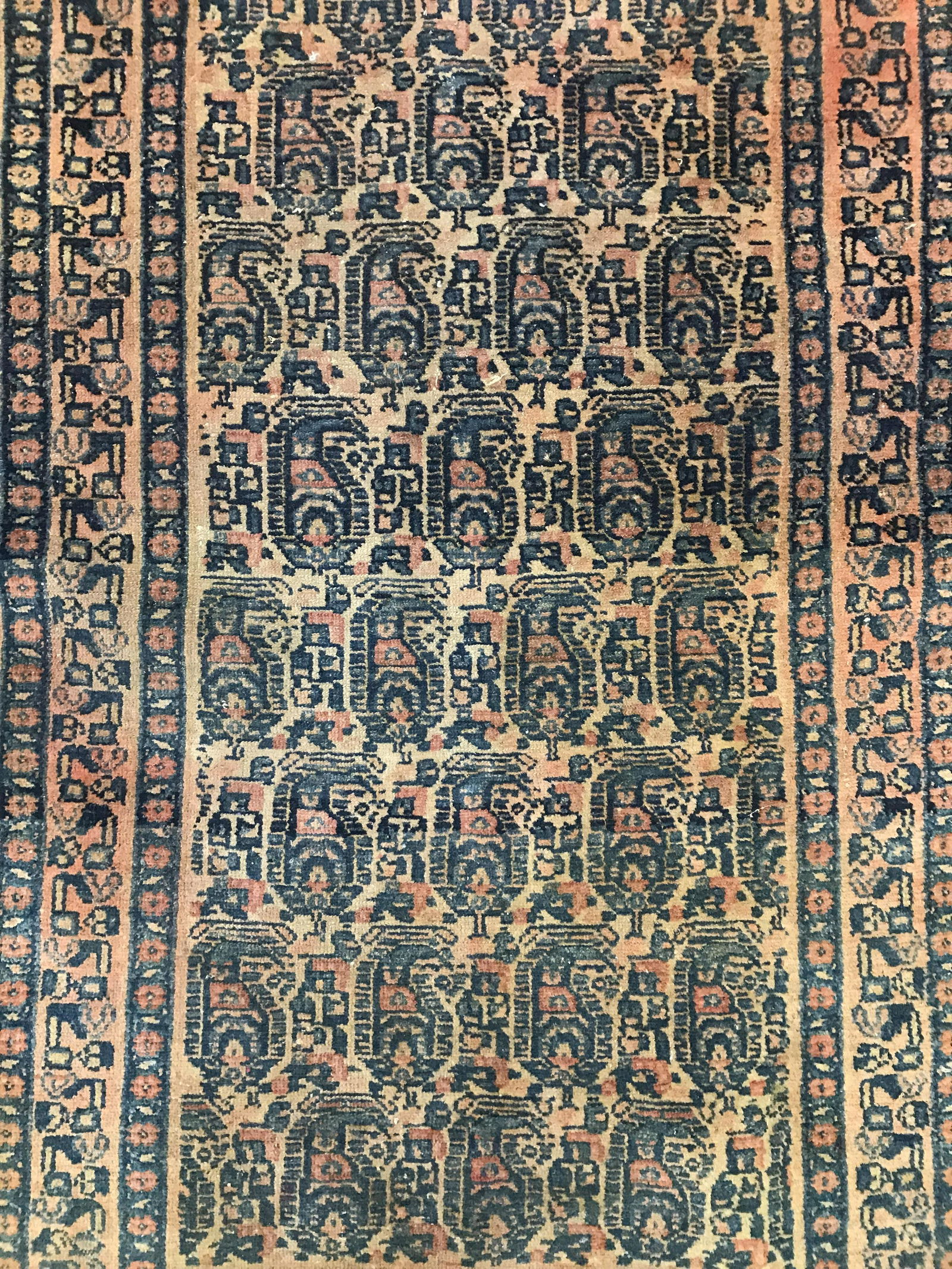 Antique Handmade Persian Wool Carpet: Rug is wool and handmade. Piece is antique. Appears to be Persian. Piece has multi toned geometric and floral detail. Rug has short fringes. Rug, carpet, area rug, wool rug, handmade rug, textile arts