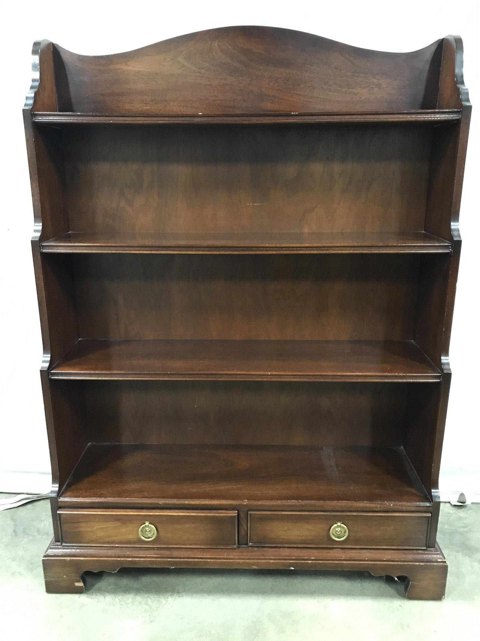 Vintage Carved Mahogany Bookcase W Drawers: Piece includes 3 shelves and 2 drawers. Piece is brown toned with gold toned brass handles. Piece measures approximately 45 inches tall 33 inches wide 11 inches deep. Shelf, vintage shelf, wall shelf,