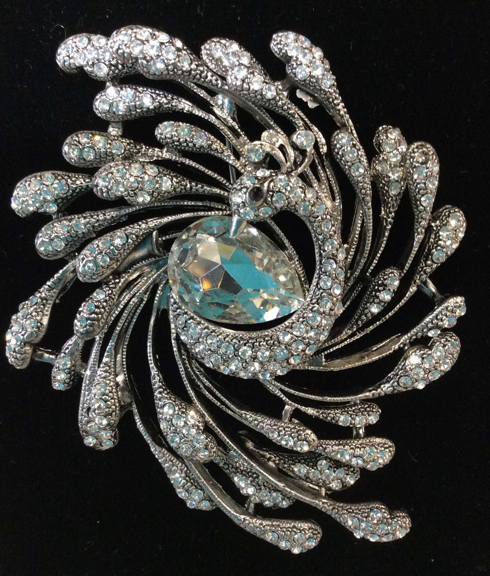 Rhinestone / Marcasite Art Nouveau Peacock Brooch: Large center pear shape/teardrop crystal 3/4 in, with bands of feathers surrounding Peacock head and body. Black crystal peacock eye. Art Nouveau Revival . 2.5 x 3 in. Property of Greenwich Connecticu