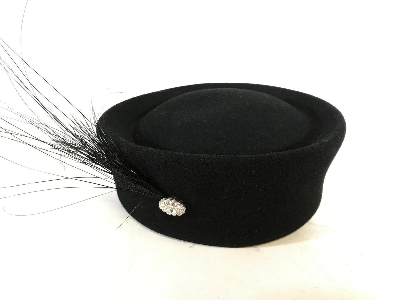Vintage TINALUXE Pillbox Hat & Feathered Accessory: Vintage pill hugs n kisses hat, labeL reads as TINALUXE COMMODORE. Hat is decorated with a feather like plume, fastened to the hat with a rhinestone laden button. Includes a hat box, hat is accompanie