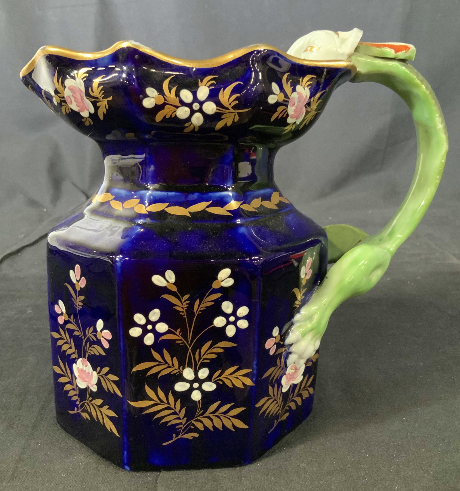 Chinese Ironstone Dragon Form Vessel: Vintage/ AntiquePorcelain pitcher, vase vessel, in rich cobalt blue glaze, gold leaf accents and unusual sculpted handle of dragon form with feet at base and head in relief curved over rim of pitcher,