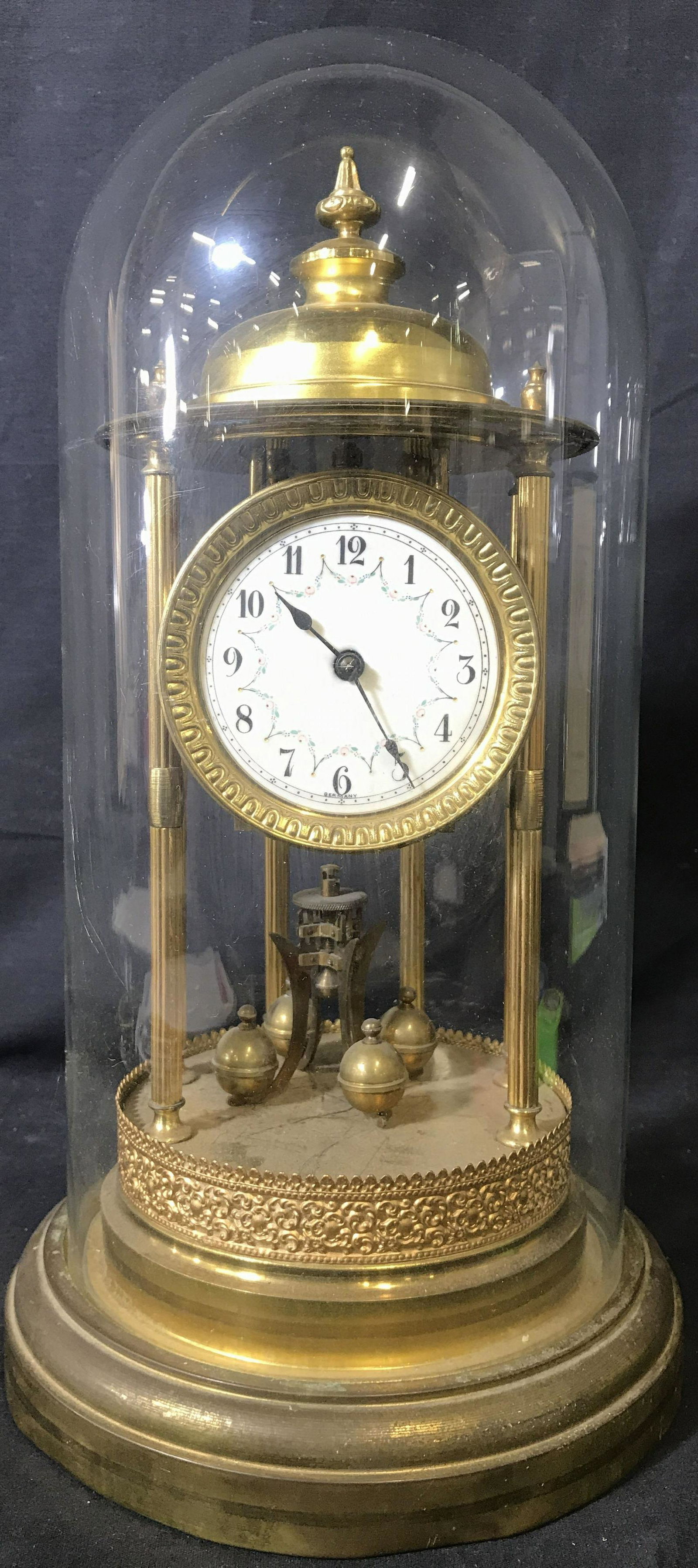 SOKOL MONTAG Bandstand Anniversary Clock: Underside of piece is marked SOKOL MONTAG. This Gold toned German anniversary clock dates to the 1920s or 1930s and has an intricately painted dial. Piece is gold toned, appears to be brass. Piece has