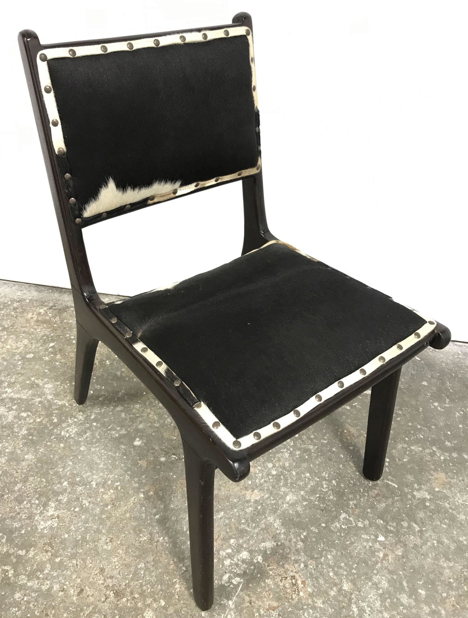 Custom Animal Hide MCM Chair: Custom side chair, wood framed, seat and back cushions are upholstered. Animal hide, possibly cow, is used as upholstery, upholstery is secured to frame through brass rivets. Back of seat is fabric se