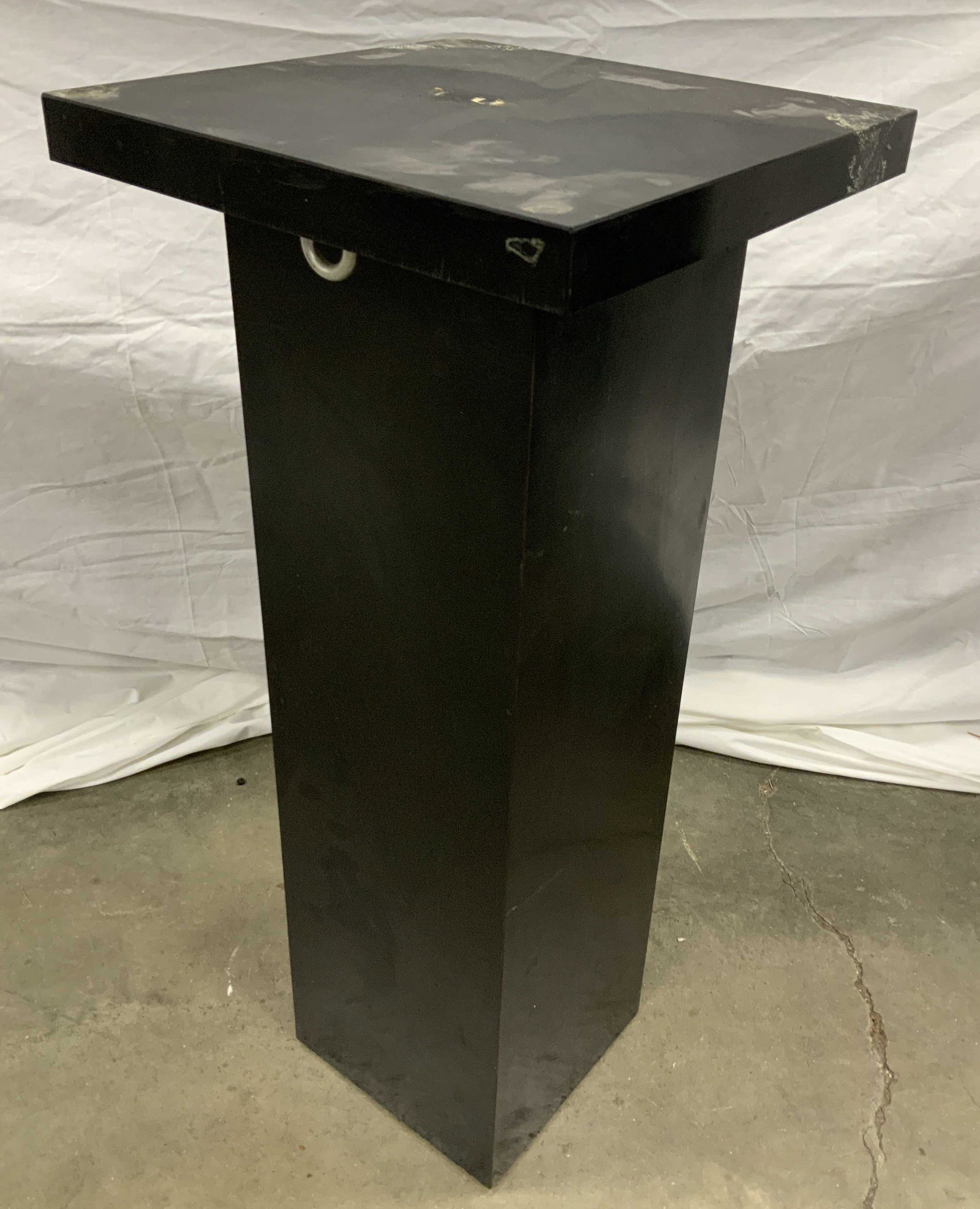 Vintage Sculpture Stand Display Pedestal: A vintage pedestal from the art studio of Estelle Goodman (1930-2007, American). The pedestal is constructed of wood and covered in a black laminate. It is in good condition with obvious signs of age