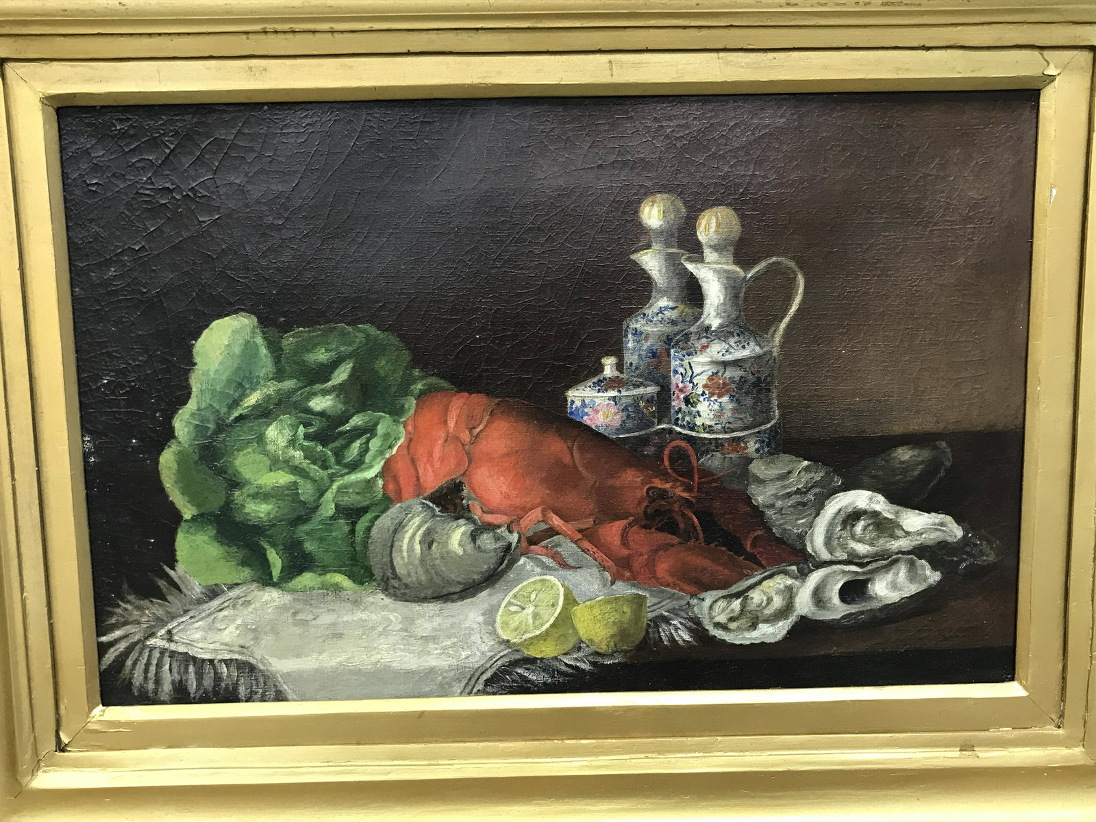 Oil painting on Canvas Still life With Lobster: Oil painting on canvas still life with lobster, no apparent signatures or stamps, subject a still life consisting of a lobster a head of lettuce oysters lemons and pitchers, gold painted wooden frame,