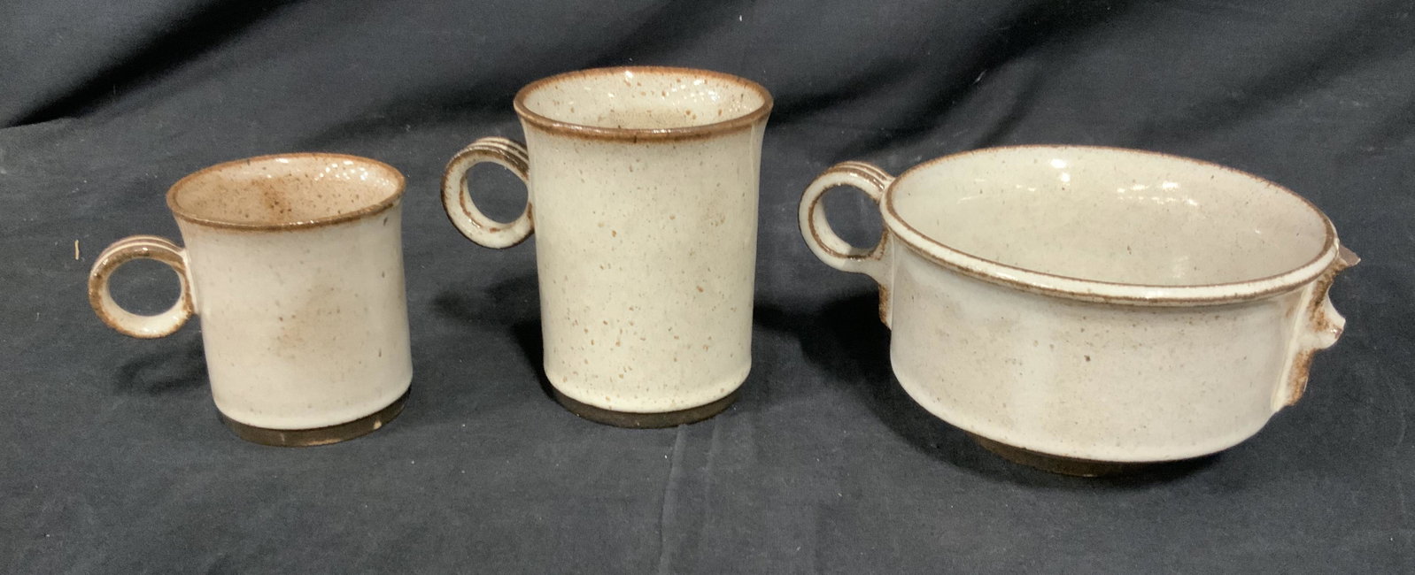 Lot 24 STOGO Danmark Earthenware Mugs: Lot 24 STOGO mugs, mugs are of various sizes. Largest piece measures approx 2.75 inches H, and 5 inches W. Wear is consistent with he and use. Underside of each mug reads STOGO DANMARK. cups, mugs, te