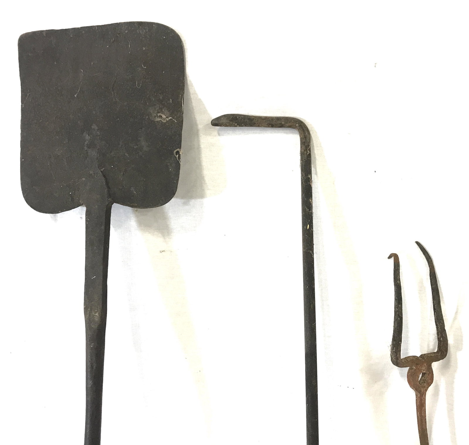 Lot 3 Antique Fireplace Accessories: 3 antique fireplace accessories, includes a shovel and two pokers. Largest piece measures approx 44.25 inches long and 7 inches W. Wear is consistent with age and use. Fireplace accessories, cast iron