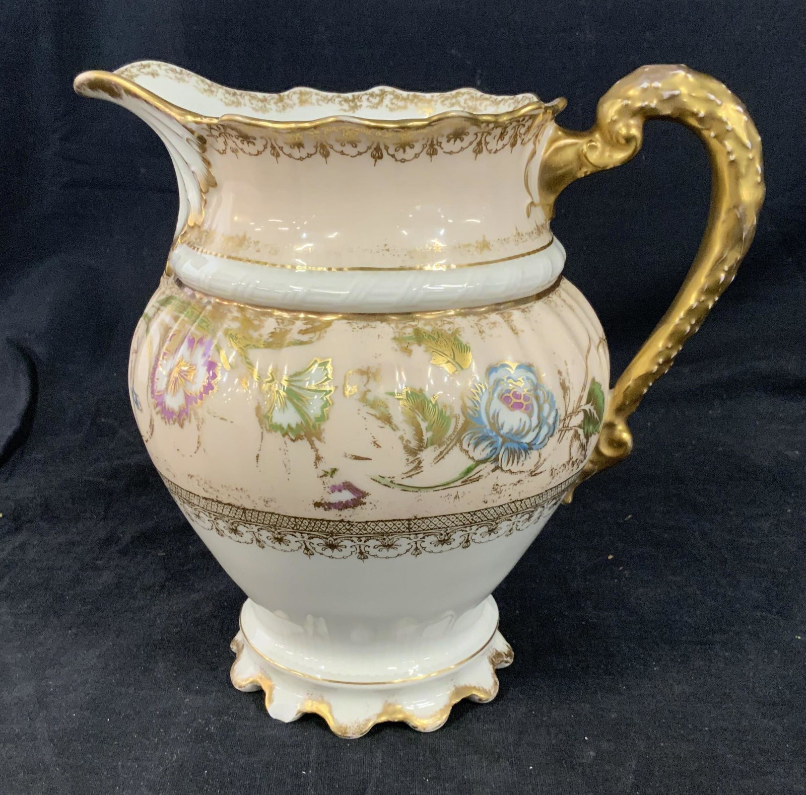 Theodore Haviland Porcelain Pitcher: Theodore Haviland porcelain pitcher, stamp to base reads ‘Theodore Haviland Limoges France’, decorative floral design with gold accents, handle, rim, and base painted gold, some wear to designs an